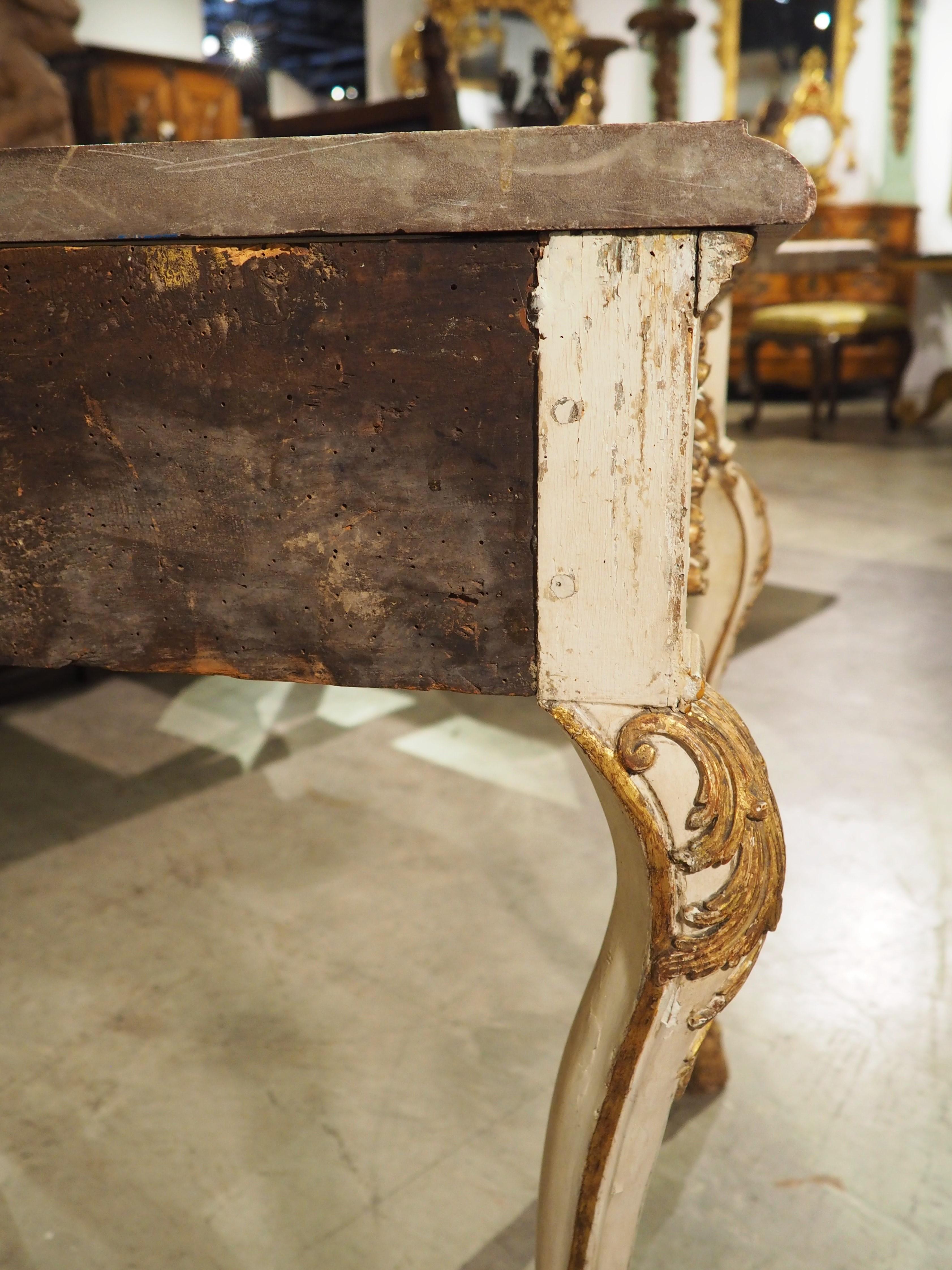 Console tables are beautiful, graceful tables that also serve a practical purpose. These tables are aligned against a wall, often between two windows and/or placed beneath a mirror. You might find accessories or artwork resting on the marble or