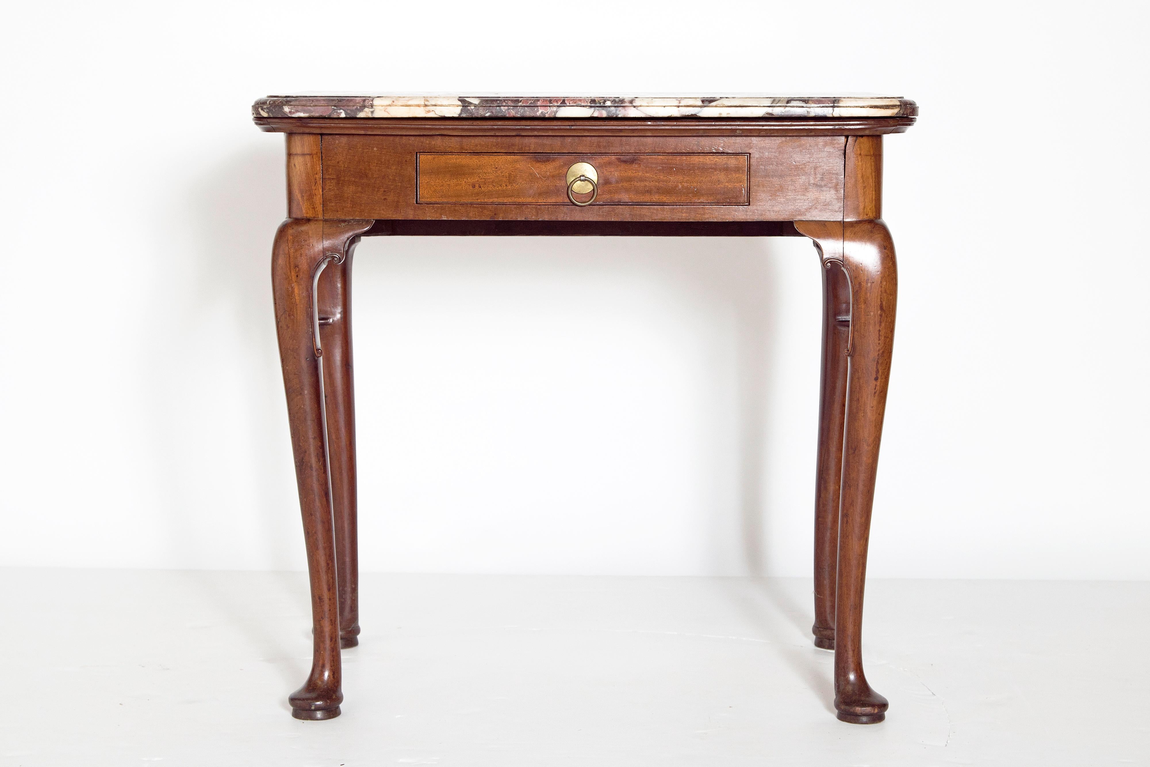 A Queen Anne mahogany side table with one drawer. Raised on cabriole legs with pad feet. Each leg knee has delicately carved C-scrolls. Shaped 