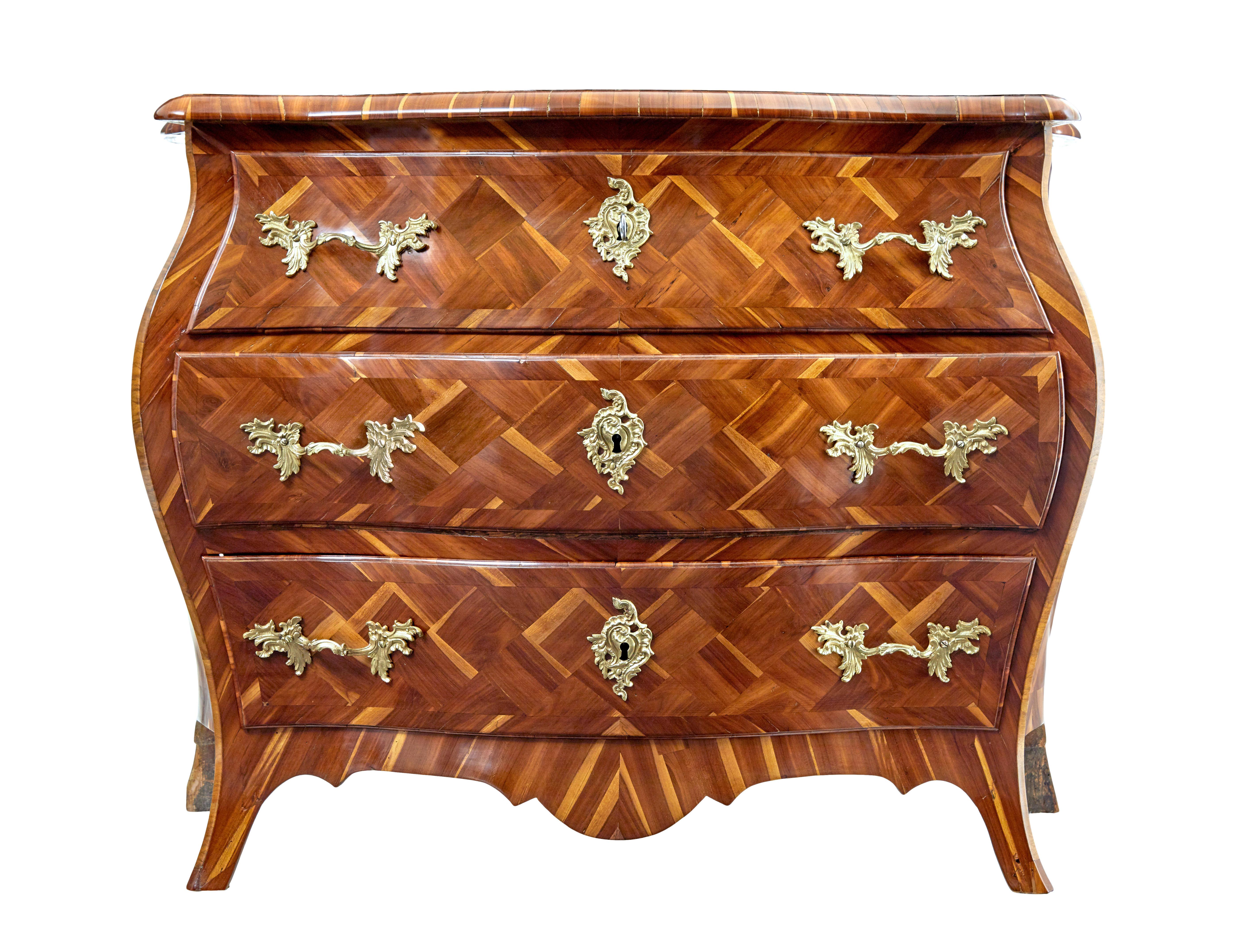 Early 18th century rococo parquetry plum bombe commode circa 1730.

We are pleased to offer one of the finest commodes we have dealt in.  Rococo period and unusually veneered in plum, which showcase's the unique natural of this wood

Parquet has