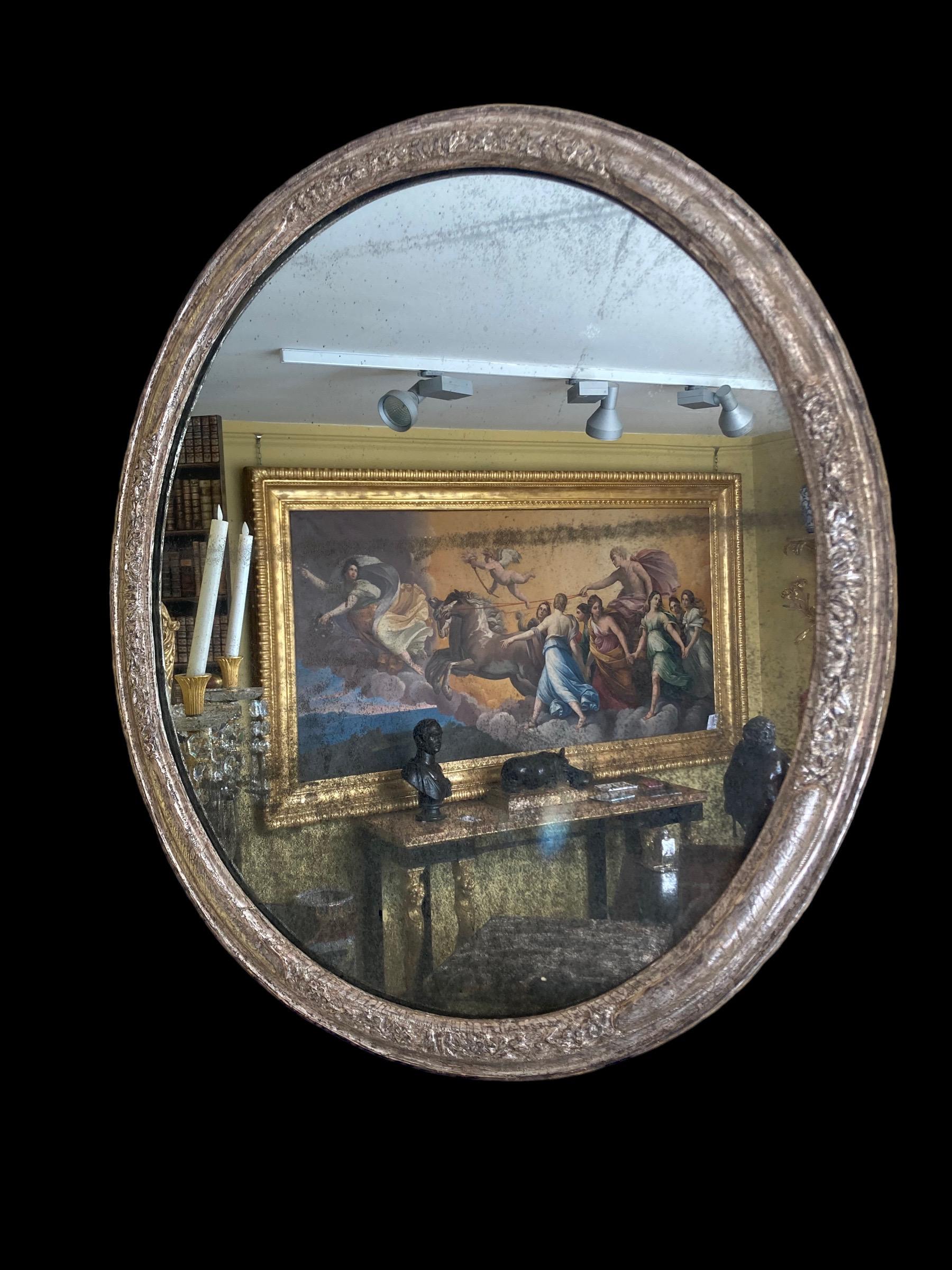 Sculpté Miroir ovale en argent doré du début du 18e siècle en vente