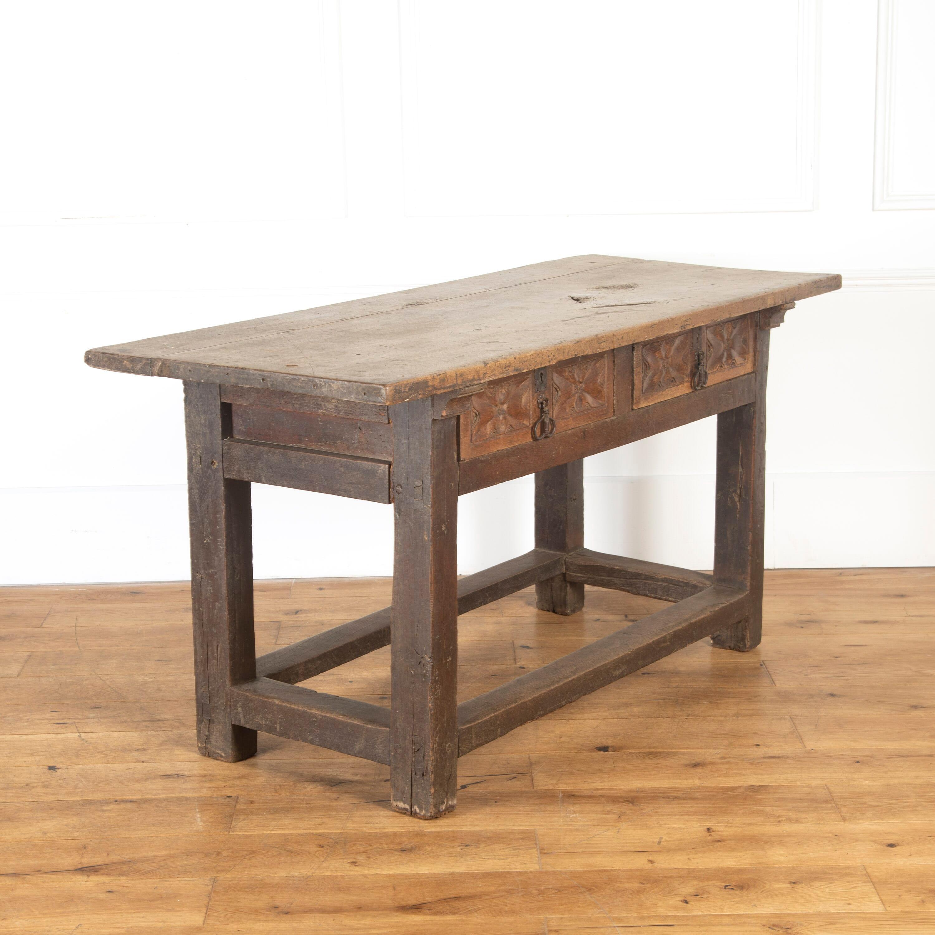 Lovely early 18th century Spanish table.

This table has two carved drawers, both have their original iron handles. 

The walnut tabletop is surmounted by a wonderful chestnut frame. 

A fantastic piece that is in wonderful condition. It has