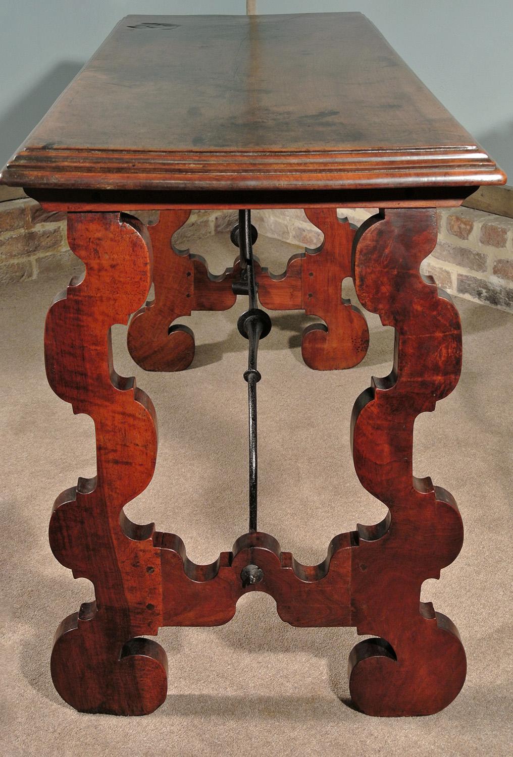 With original scrolling ironwork and in superb original condition, this substantial Spanish centre or sofa table is made from solid walnut and dates from circa 1630. 

The lovely overhung single slab top with stepped and shaped border - made from a