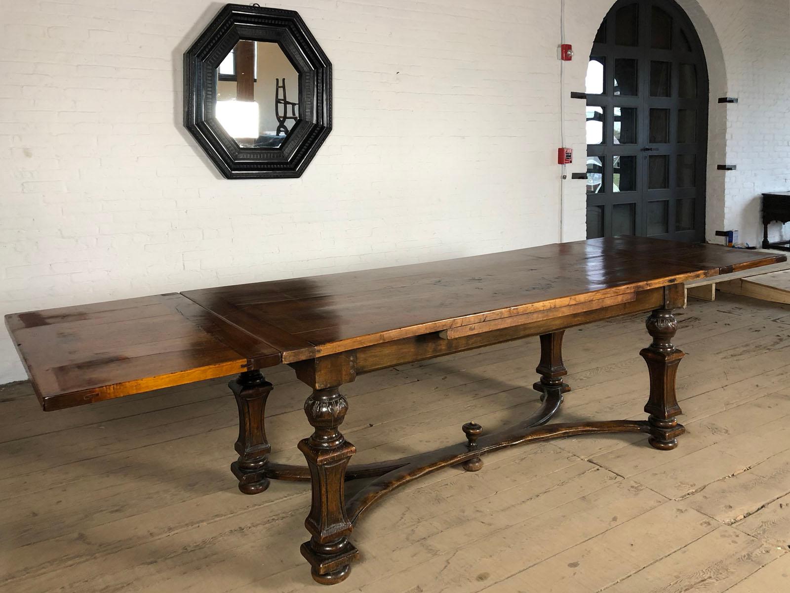 A Southern Swiss or North Italian walnut draw-leaf table of elegant, unique design.
The draw-leaf mechanism allows flexibility, from seating comfortably six when closed to 10 when extended.
The extension leaves can be pulled out from under the top
