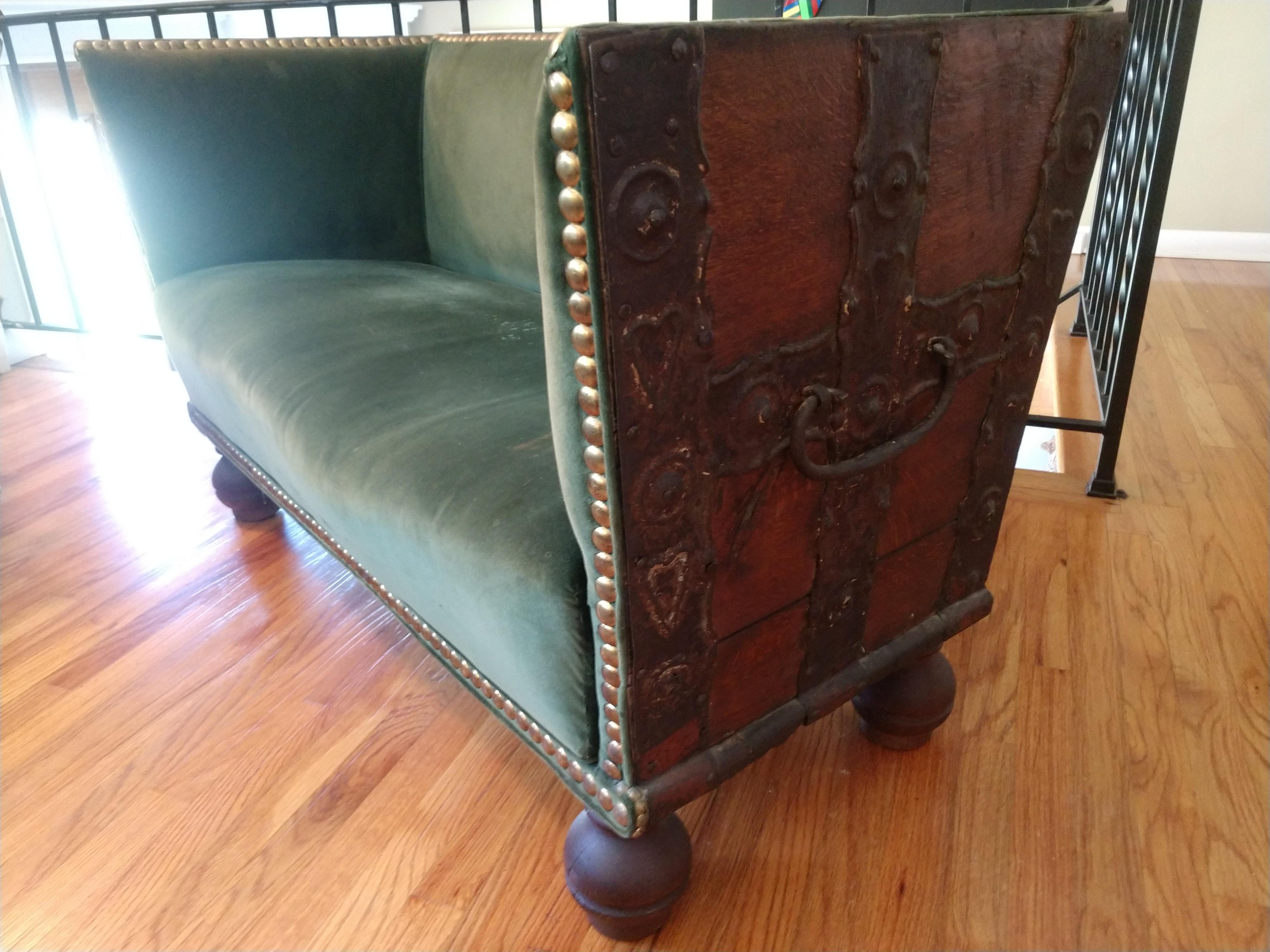Fabulous transformation of a 18th century treasure chest remnant into an amazing love seat / lounge chair. Probably outfitted in the fifties with mohair upholstery and large button tacks. Sitting on ball feet a real striking piece. Photos cannot