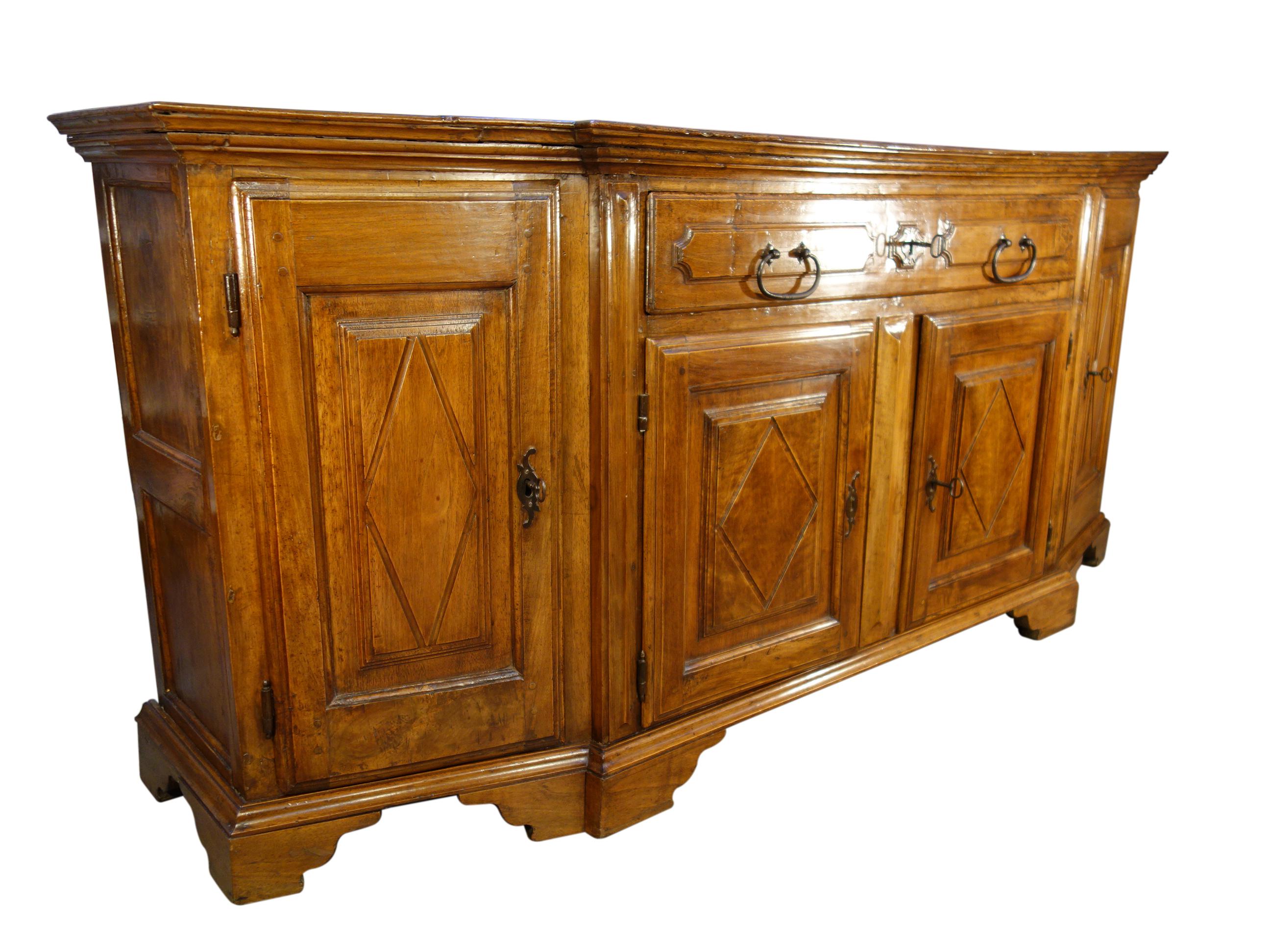 18th century 4-door walnut Scantonata credenza with 1 centered large drawer and angled sides. Handsome architecture & carved diamond (losanghe) details. Beautiful grain with classic patina. Forged hardware, large pulls, locks & keys. Well preserved,