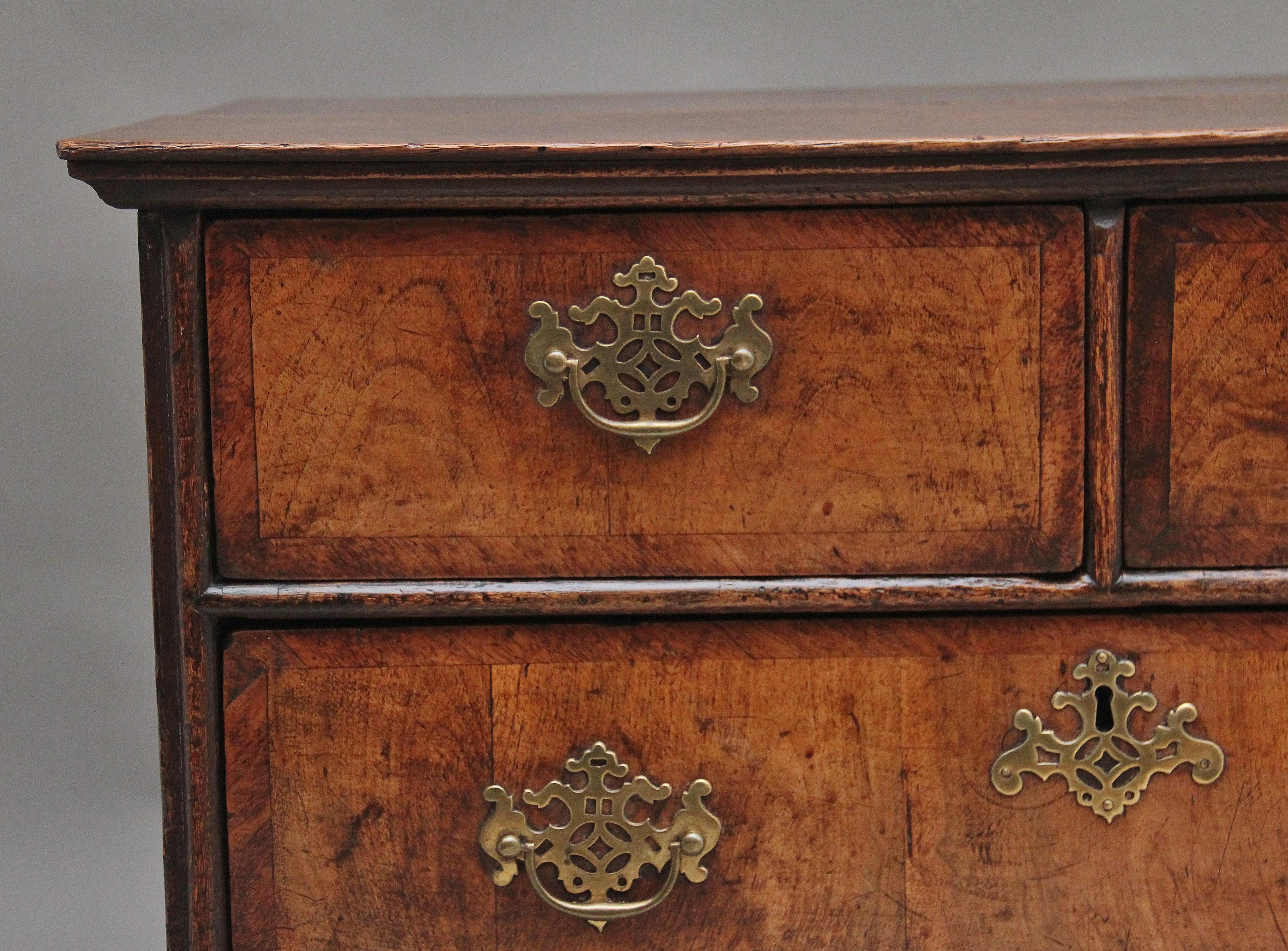 Early 18th Century walnut chest of drawers, having a nice figured top above a selection of two short over two long drawers with pierced brass plate handles and escutcheons, raised on bracket feet.  In very good condition and having lovely figuration