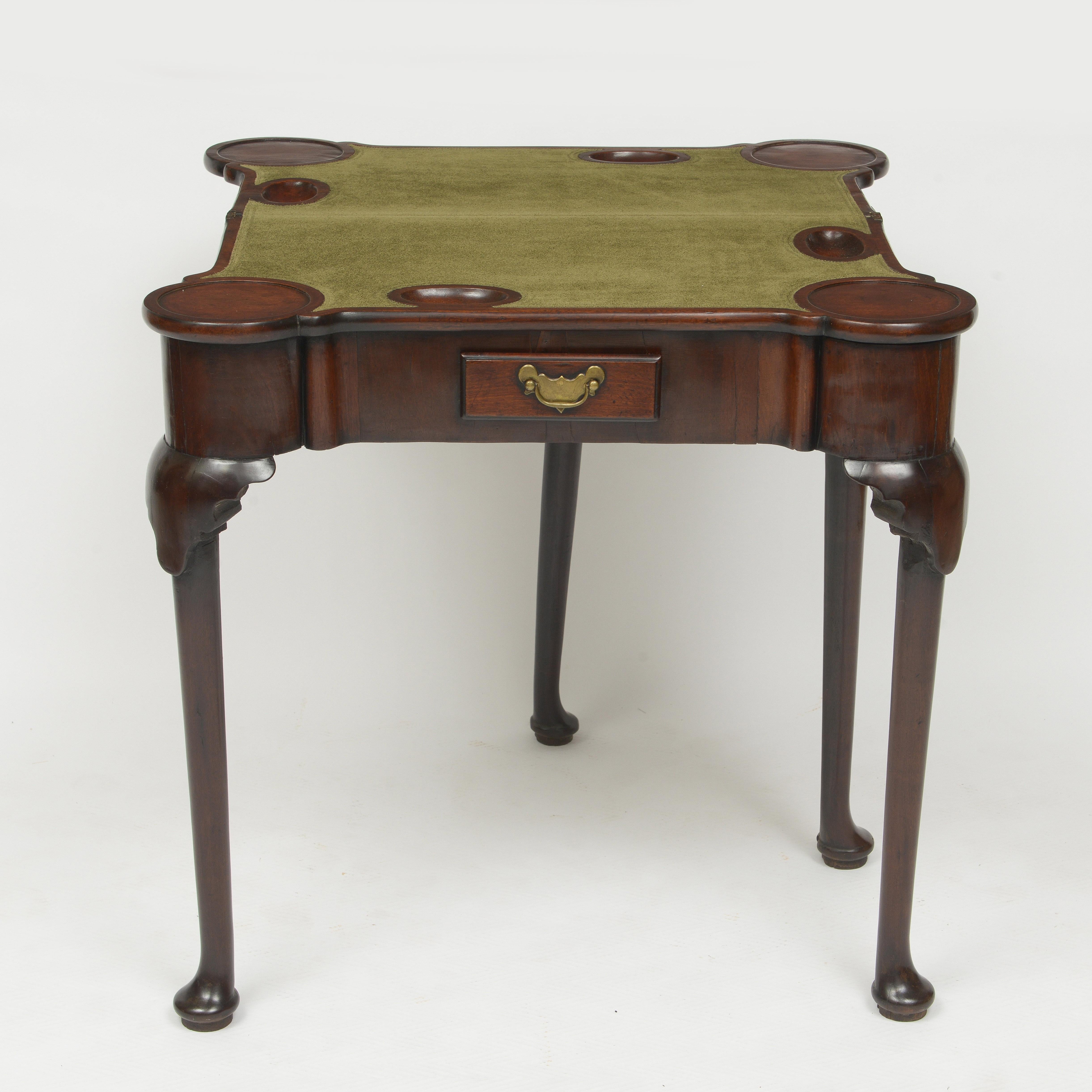 18th century walnut gaming table with green suede playing surface.
Fold over table is supported by a single gate leg.
Contains a single drawer with period brass handle
When open to card table it measures 30” x 30”