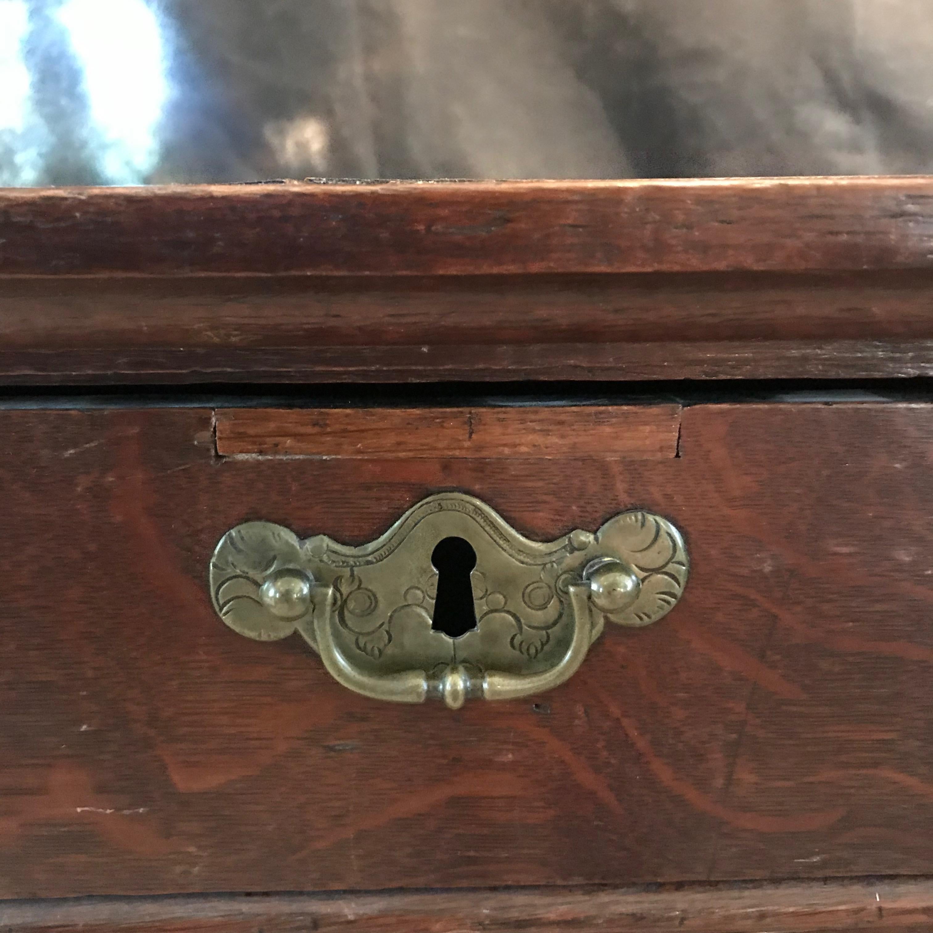 Early 18th century oak William and Mary British chest on stand having beautiful original hardware. Bought in the North of England. 
#5339.
 