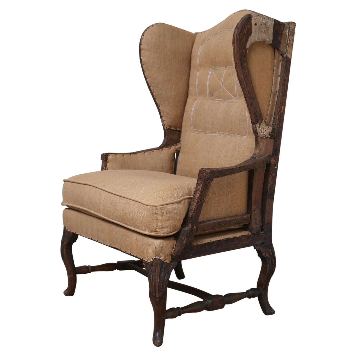 Early 18th Century French Deconstructed High Wing Back Fruitwood Armchair For Sale