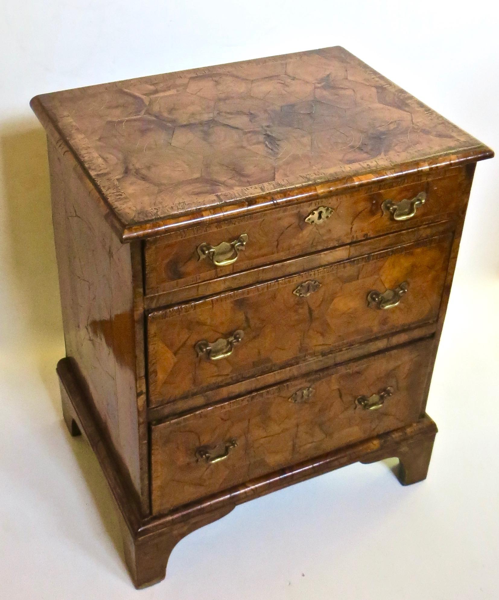 Highly Figured Walnut Laburnum Oyster Veneer Three Drawer Chest on four bracket feet, with later brass pulls and escutcheons; cross banding to the drawers and top; great surface and color, with pleasing mellow patina (see images); some elements