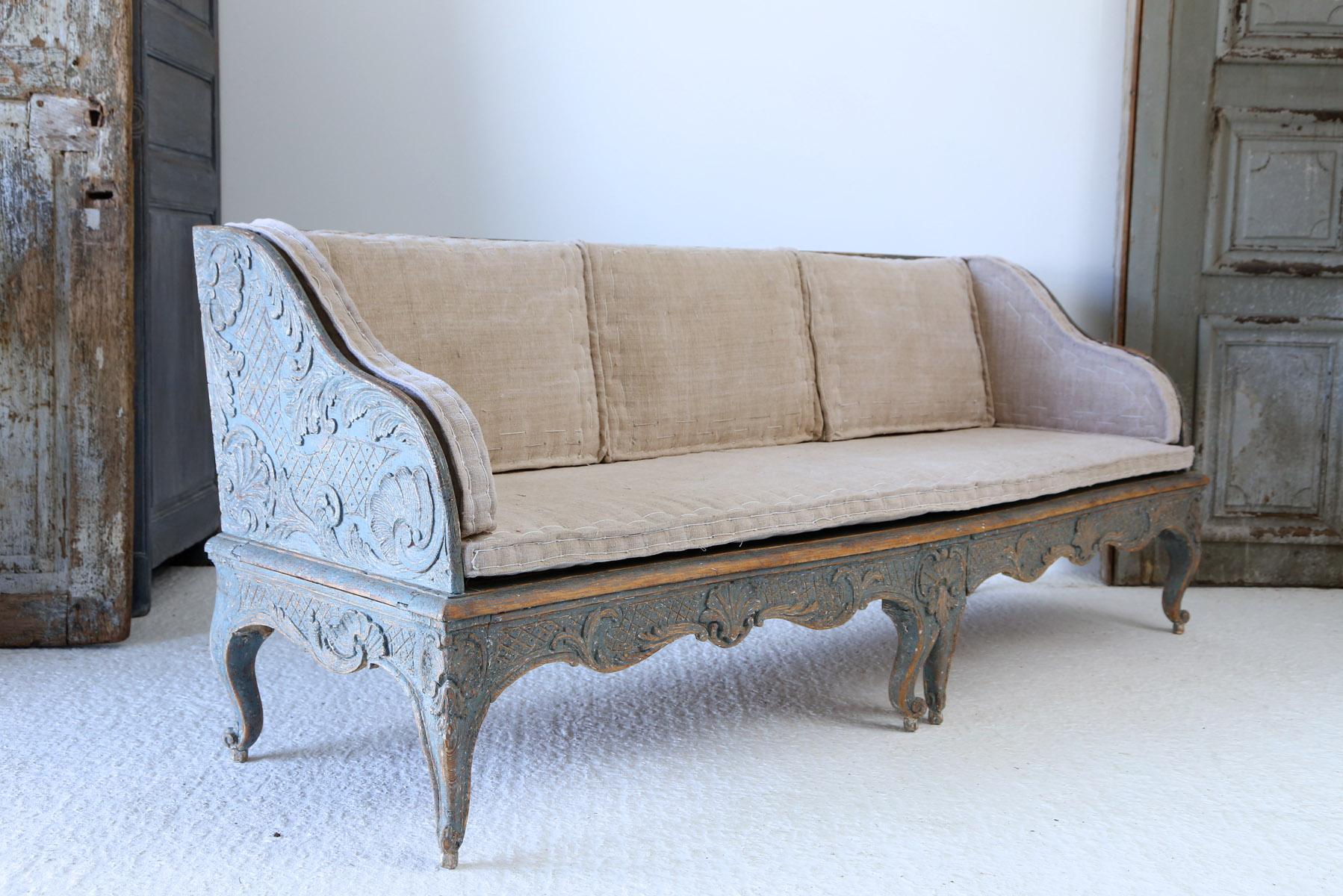 A fine example of a 18th century Swedish carved wood sofa with original paintwork and later upholstery. The carving on the sofa is extremely good with lots of detail