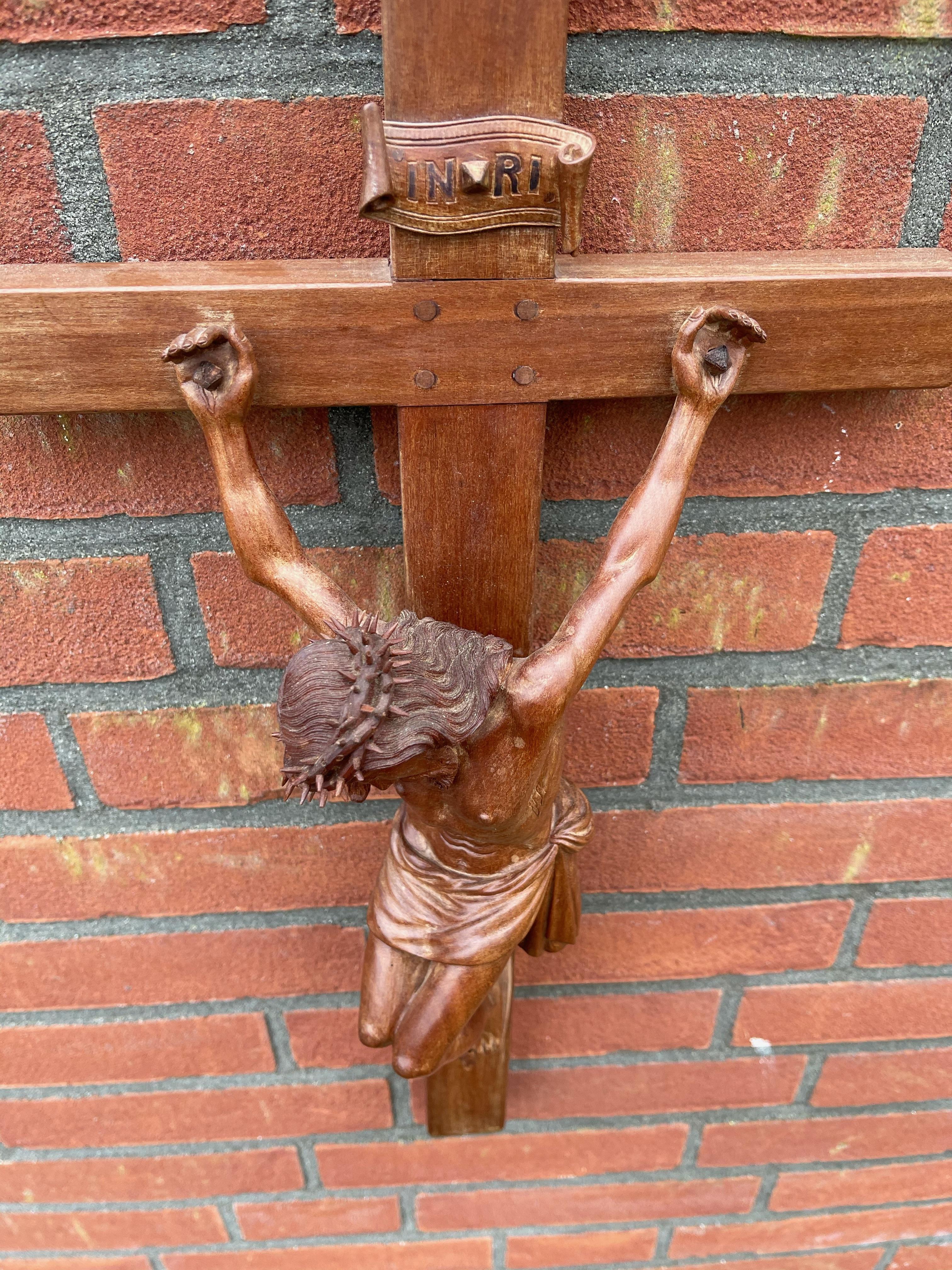 Sizeable crucifix with a quality carved corpus of Christ with unique facial features.

Looking at Christ suffering like this, the crucifix (in our view) is a symbol of what 'telling people the truth' can lead to. 'The truth does not have many
