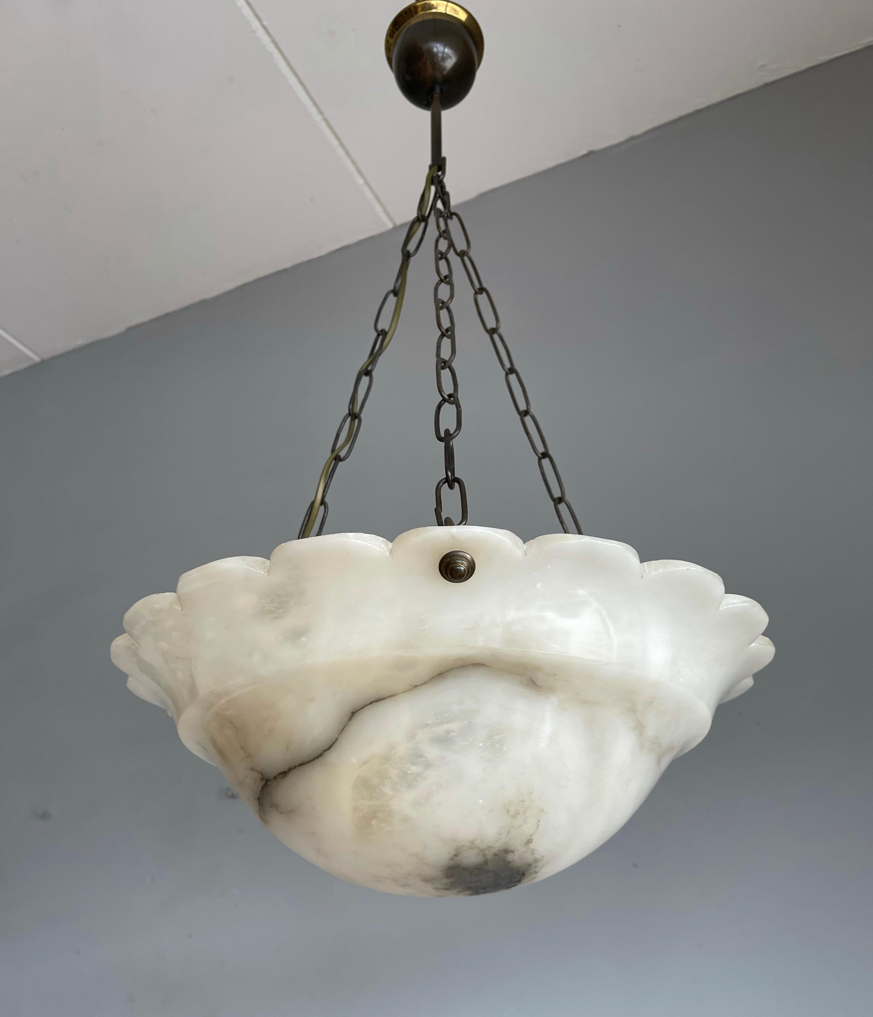 Wonderful and good size Art Deco alabaster pendant in mint condition.

This beautiful sunflower design, top quality Art Deco pendant is both unique in shape and color. Many alabaster pendants are more beige than white, but this example is