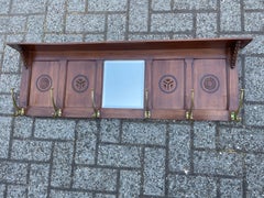 Early 1900 Arts & Crafts Coat Rack with Stylish Carved Panels and Beveled Mirror