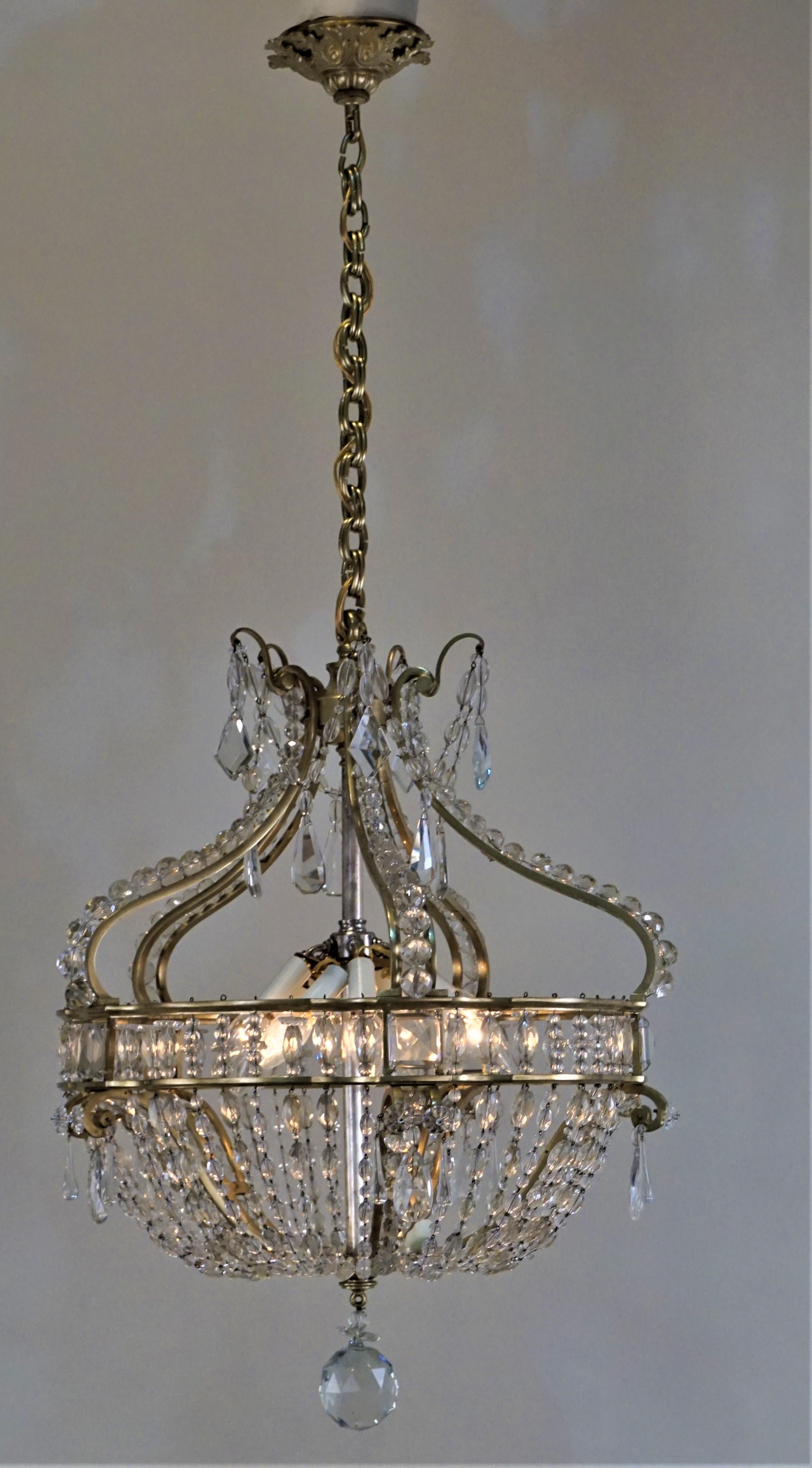 Elegant French early 1900 cast bronze frame with beautiful cut crystal prisms and chain chandelier.
Measurement: 21