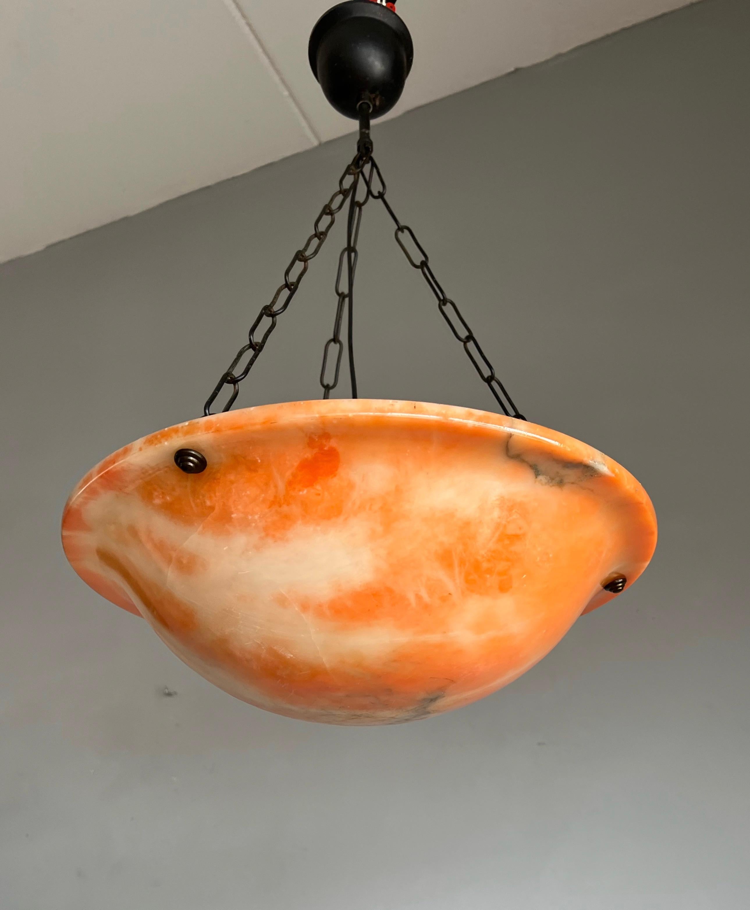 Lovely handcrafted and good size alabaster dish / bowl pendant.

This Art Deco pendant has a beautiful and timeless design, but what makes this particular pendant really rare is its many 'faces'. This alabaster light has a different look from every