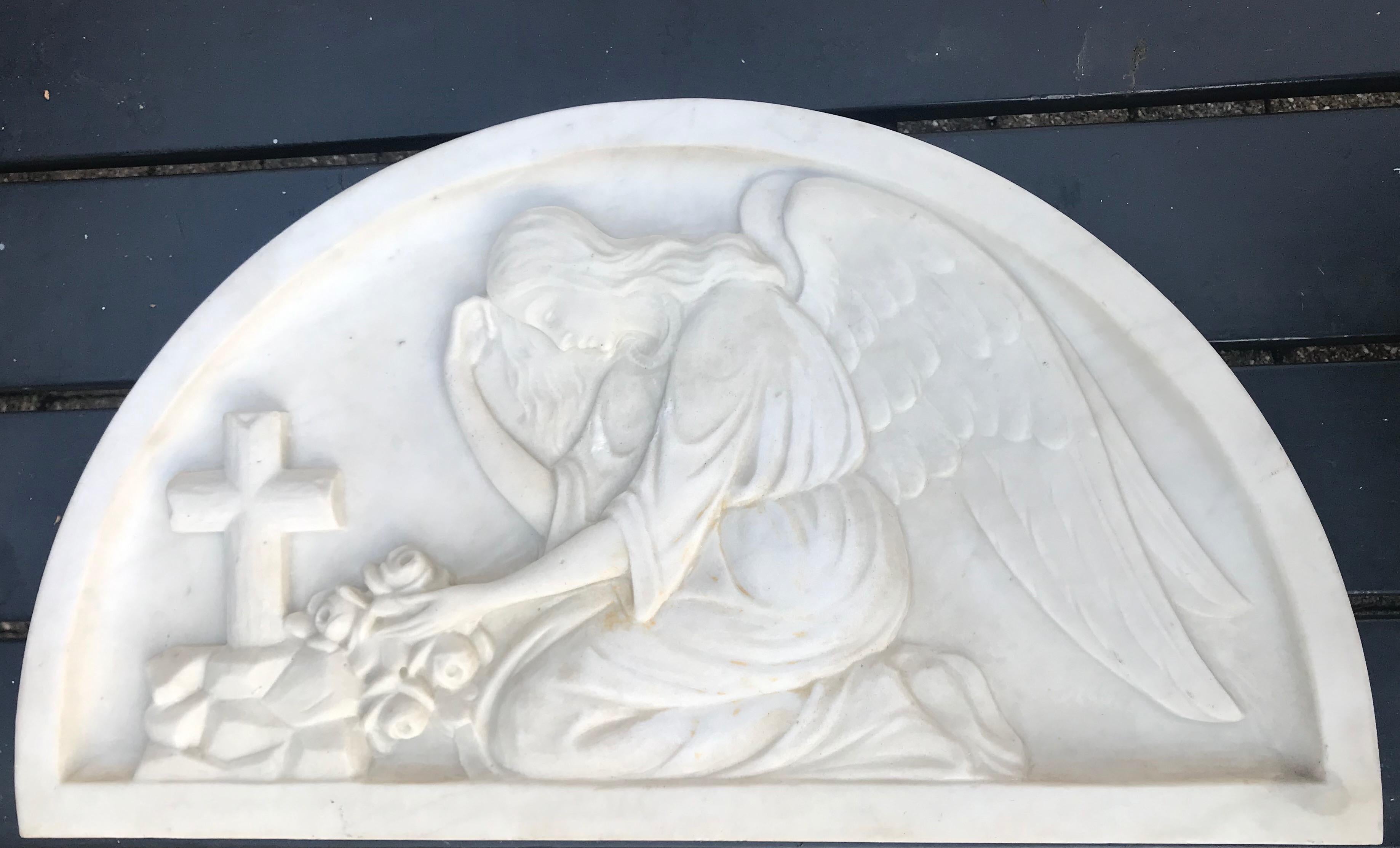 Hand-carved kneeling angel in relief. Marked/Signed picture 4.

This mourning angel by a grave is entirely hand-carved out of marble. This early 20th century Christian work of art can be used hanging on the wall or standing on a shelf. The natural