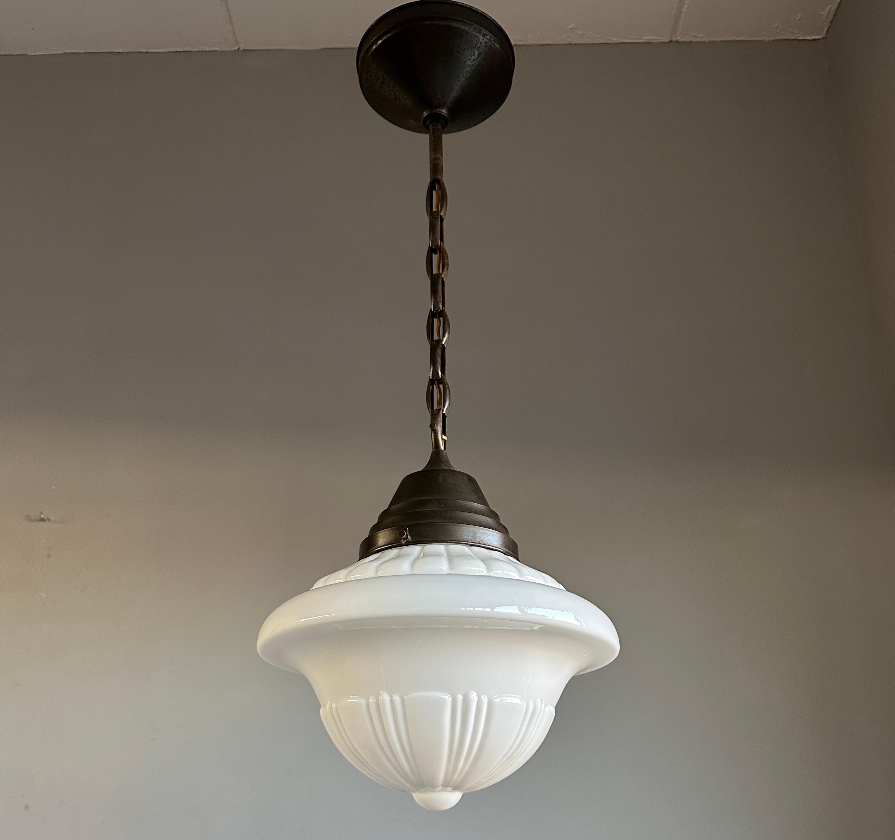 Highly stylish glass-art pendant light with stunning chain. 

This rare and stunning 1920s Art Deco pendant is of museum quality and condition. The combination of the beautifully designed, clean white shade and the excellent brass chain is a match