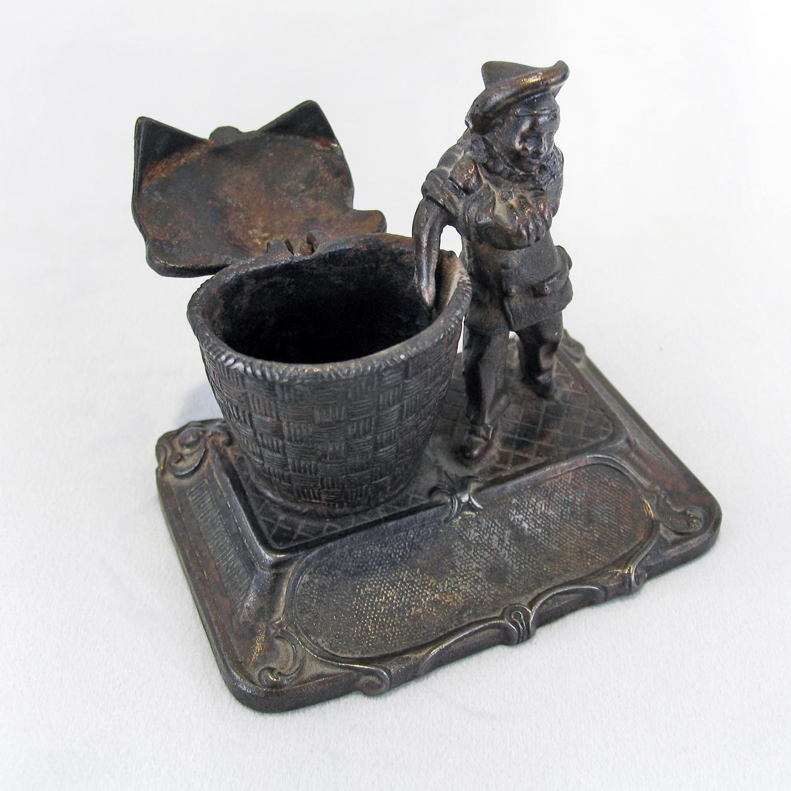 Early 1900 Russian inkwell, depicting a boy sleeping his hand in a basket. Cast metal with dark patina, marked to the bottom. Excellent condition accordingly to its age.
Dimensions: 11 x 9 x 10 cm.