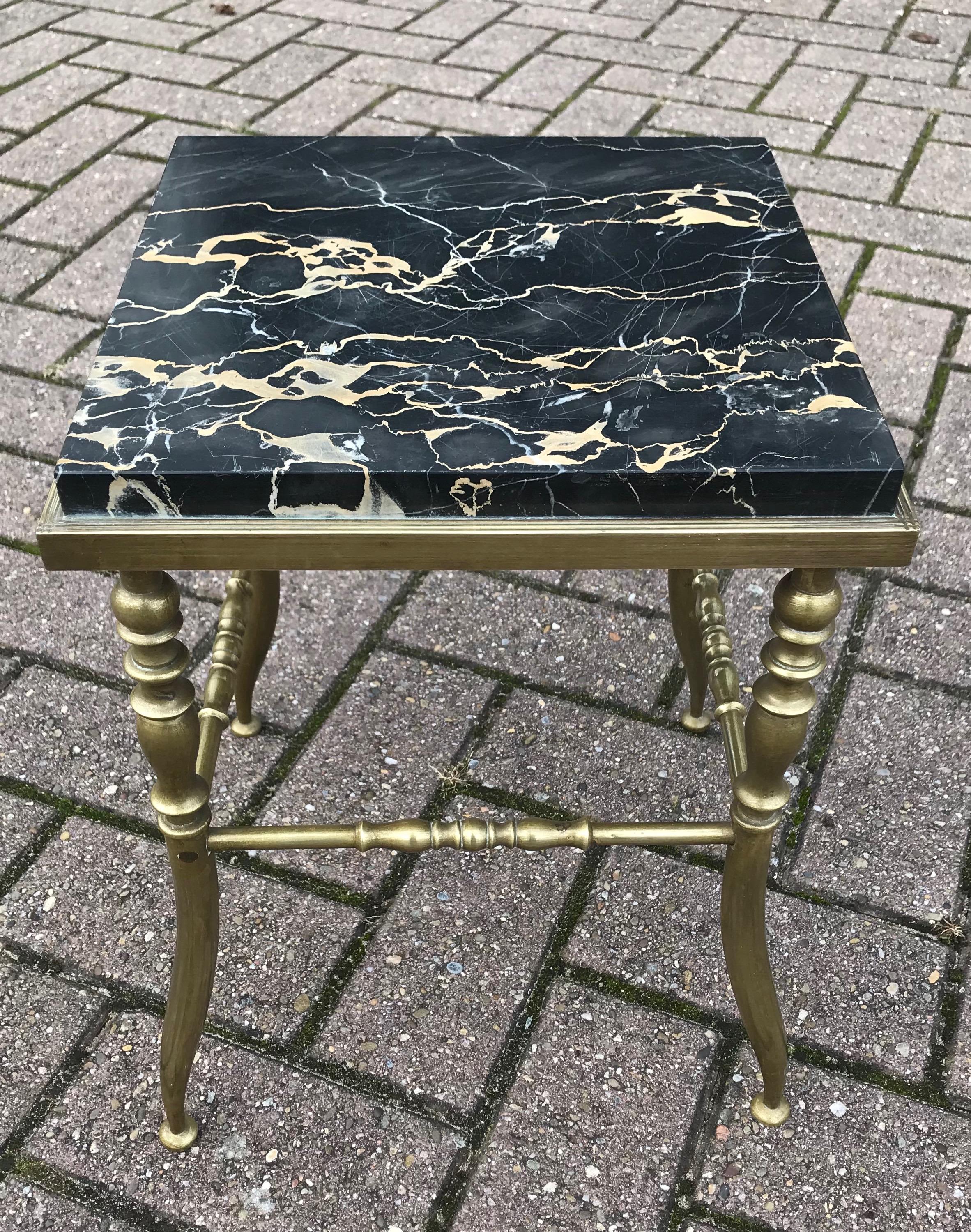 Beautifully stylish and strong antique stand.

This very elegant and handcrafted table can be used in all kinds of interiors and for all kinds of purposes. The strong bronze frame stands as firm as the day it was made and the perfectly inlaid black