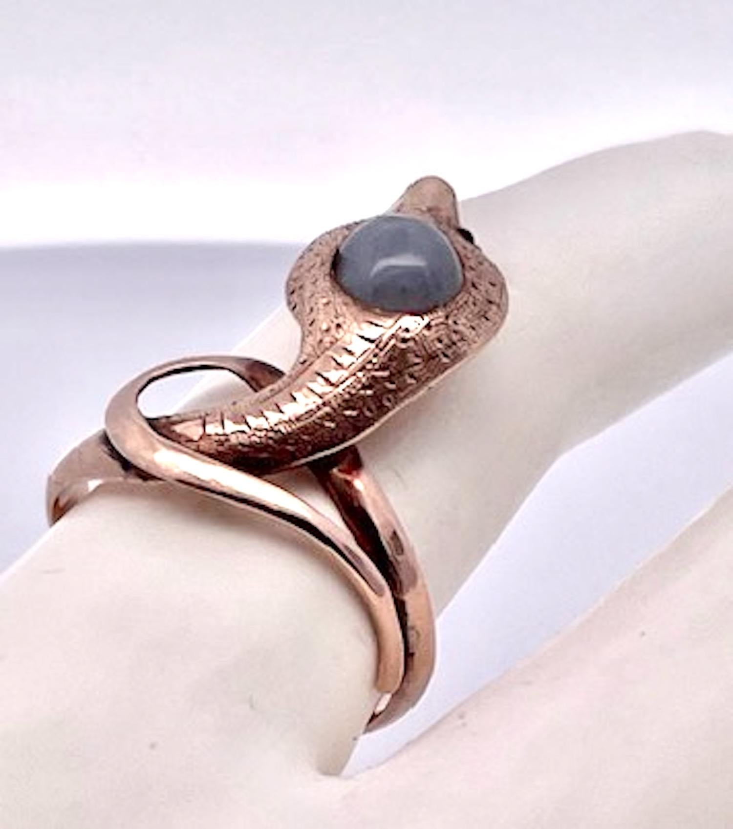 This is an early 1900 snake ring.  Although it is only 9K Yellow gold the head is set with a Star Sapphire with an etched neck and head.  The head has 2 small ruby eyes and the rest is smooth gold.  This weighs in at 4.04 grams and is currently a
