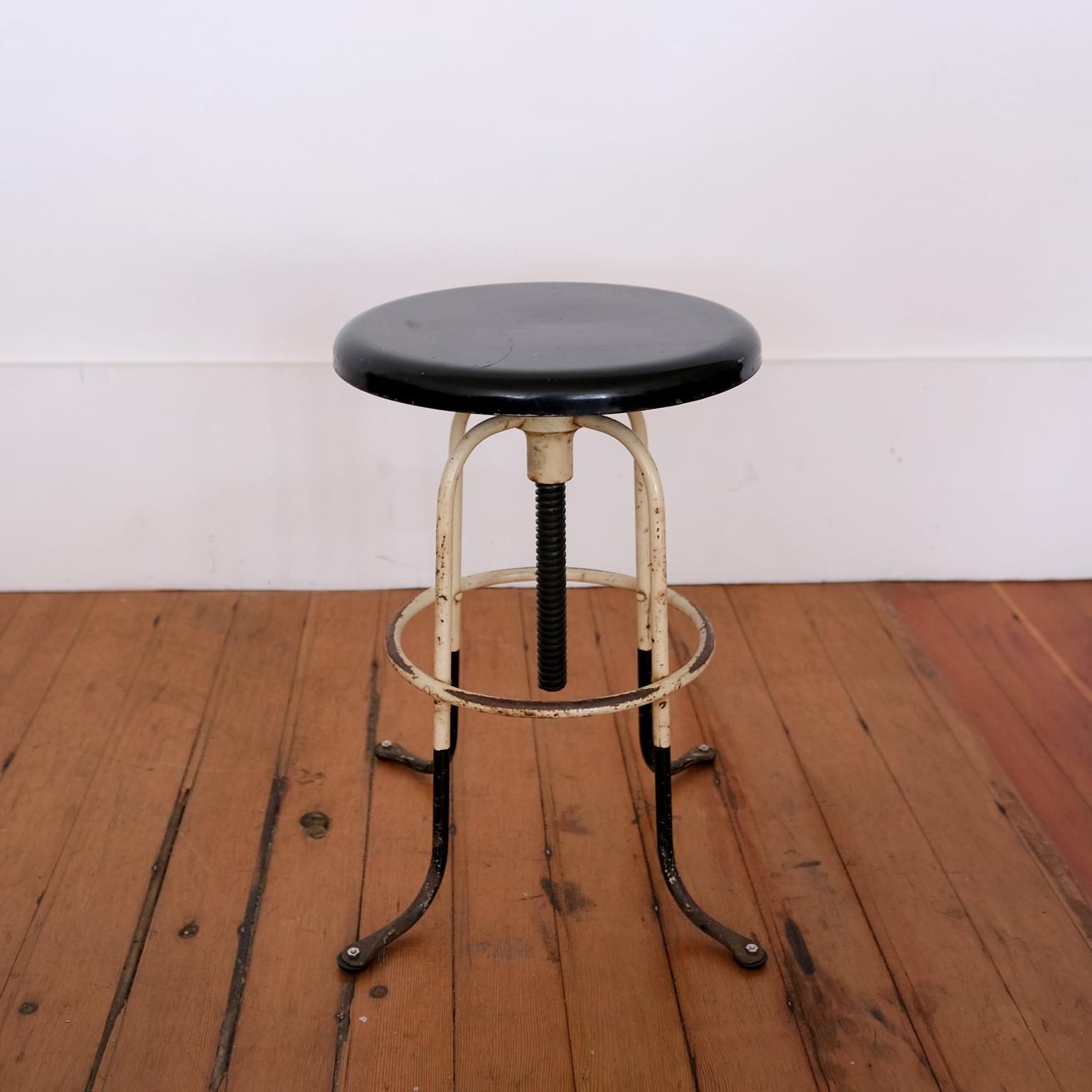 Solid steel adjustable height stool. Rotating seat raises and lowers the height from 18