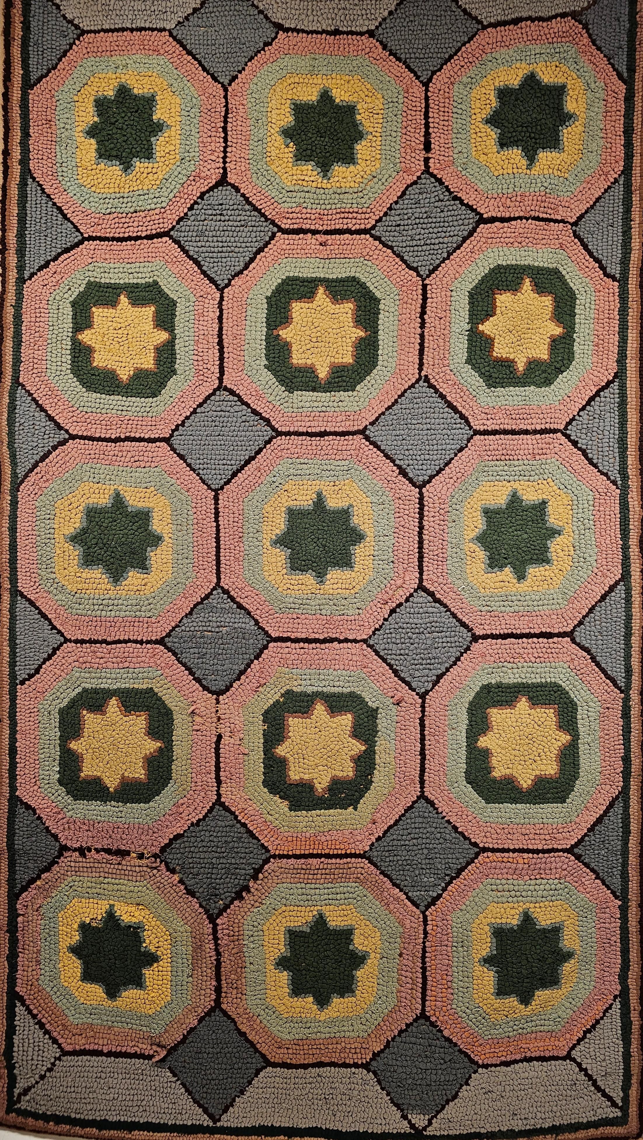 An American Hand Hooked Rug from the early 1900s in a geometric pattern with pastel colors in gray, blue, pink, and yellow.  The use of special design and the brilliant colors makes this truly an artistic piece wonderful to be used as a wall