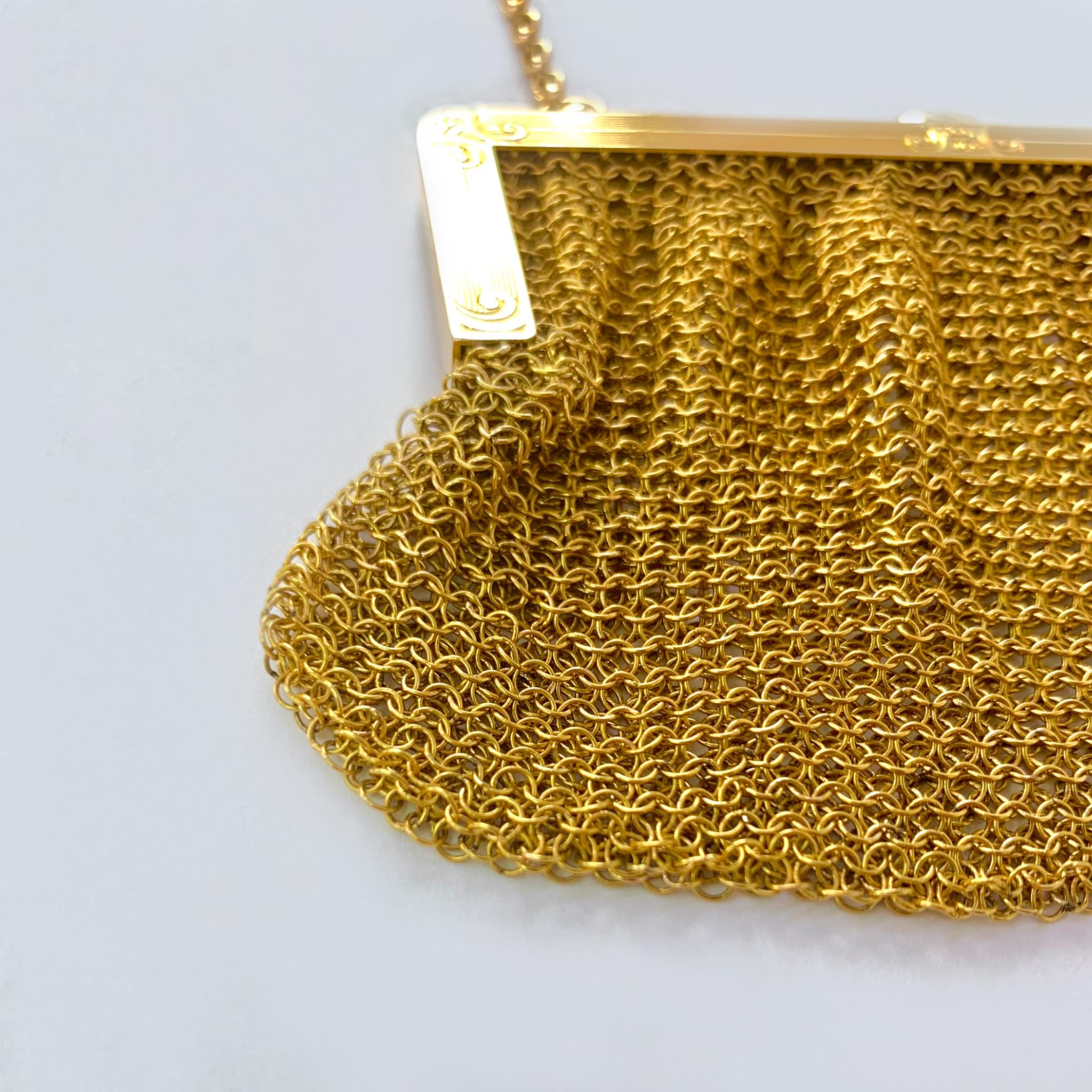This beautiful antique, circa early 1900's, mesh 18 karat yellow gold purse is a charming piece of history. Hundreds of tiny gold links were hand woven together to make this masterpiece. It has a garnet push clasp and filigree designed opening,