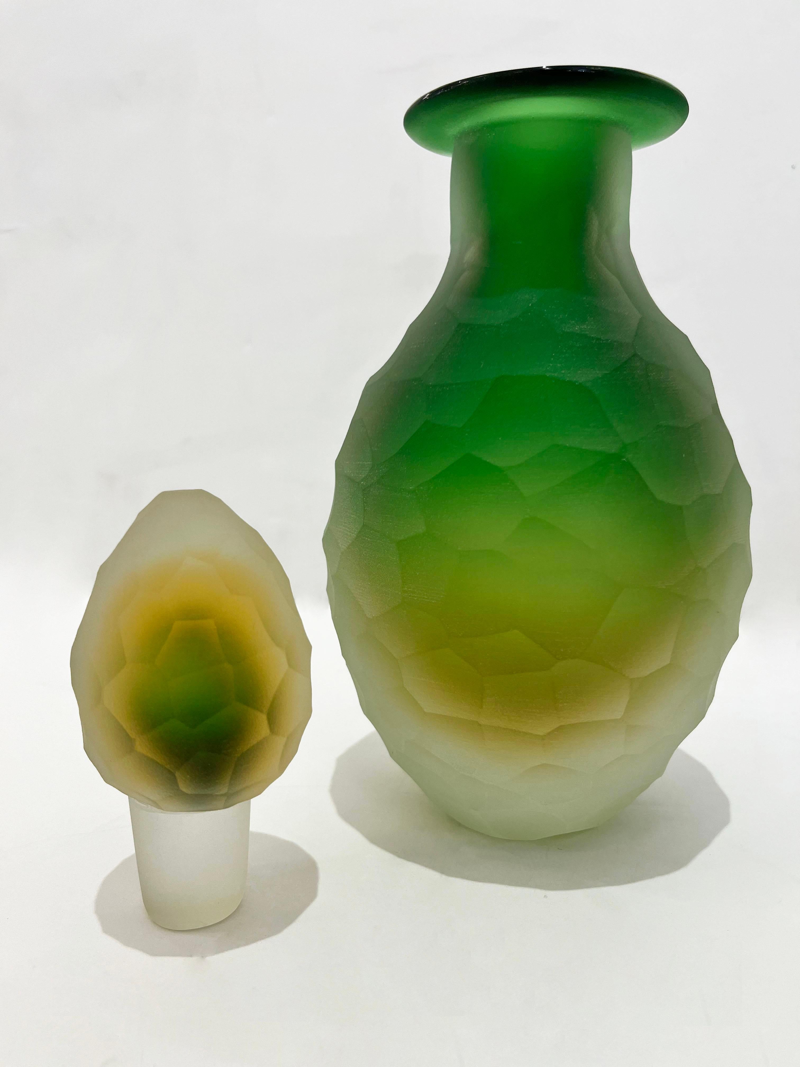 An early 1900s Art Deco Venitian bottle in Murano glass by Cristallerie Franchetti, a rare object for the size and the elegant sophisticated work with the Sommerso technique: the green central body encased in a yellow color layer, within the crystal
