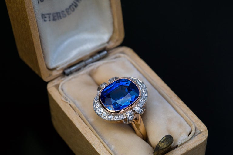 This early 1900s  well made antique Russian ring features a 4.68 ct natural, eye-clean, very rare Kashmir sapphire of a pure blue color.

The sapphire is framed by a halo of old mine cut diamonds set in platinum over 14K gold and flanked by