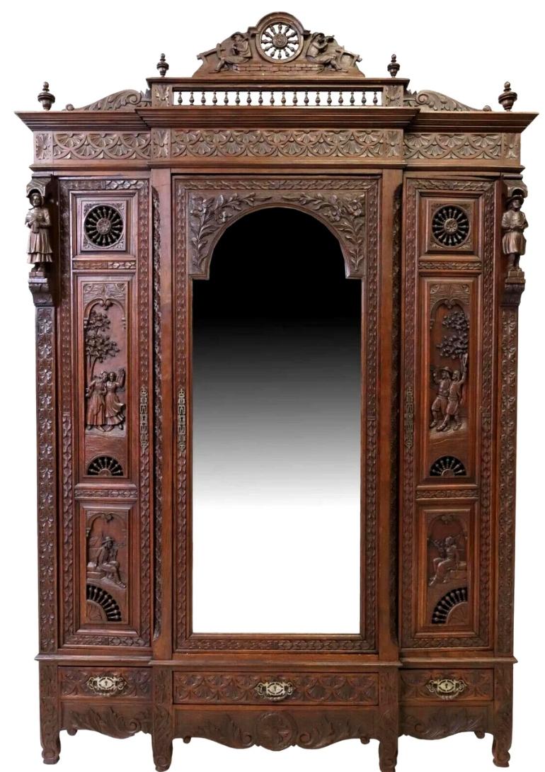 Gorgeous Early 1900s Antique triple, French Breton, carved Oak, mirrored armoire!!

This French Breton carved oak breakfront armoire, sometimes known as Brittany, was made in the early 20th Century. It has the well-known spindled wheel crest,