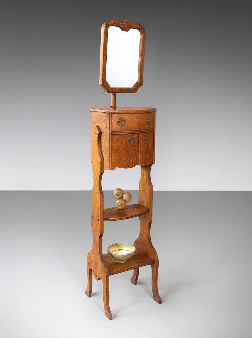 Condition: Original Vintage Condition 
Materials: Tiger Oak, Original Mirror, Brass Pulls
Style: French Art Nouveau

This early 1900s Art Nouveau–style gentleman’s shaving stand captures the charm of old-world daily rituals, when grooming was a