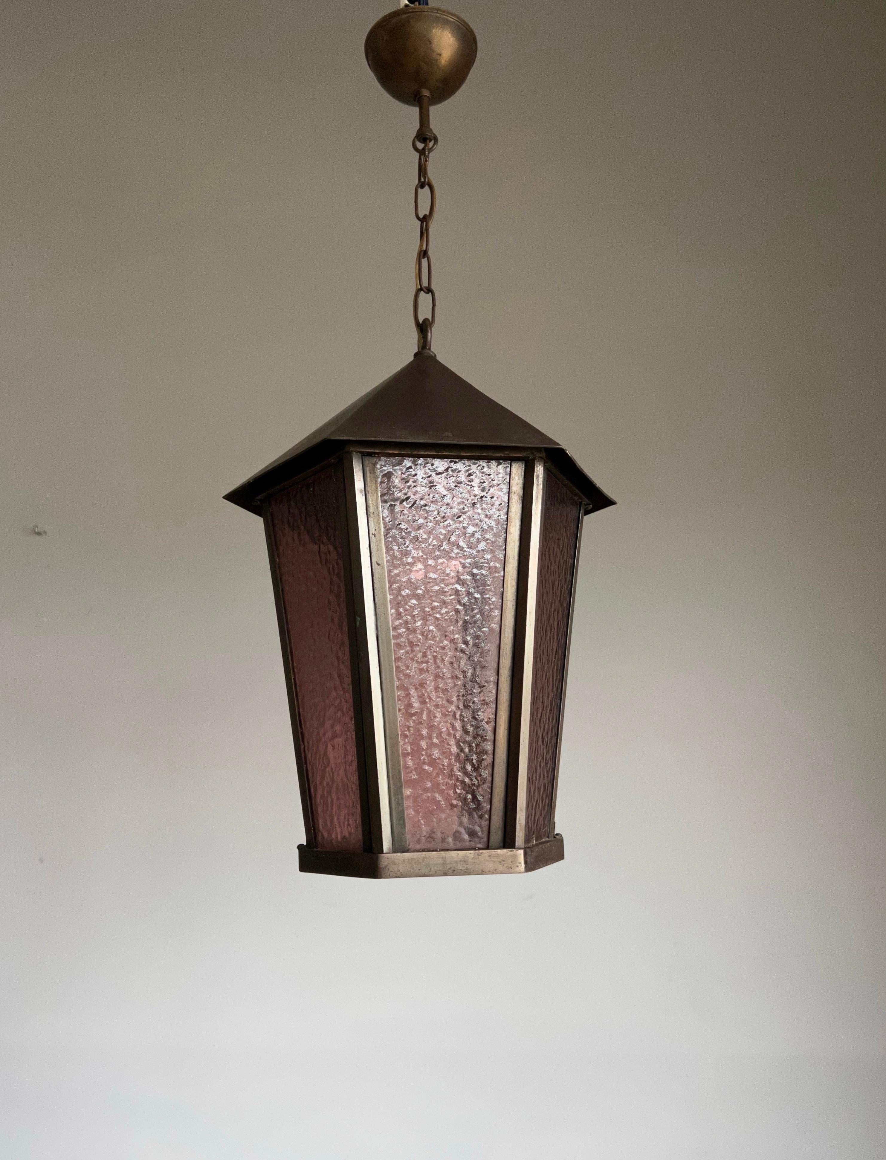 Unique and all handcrafted, hexagonal light fixture with purple color cathedral glass. 

If you are looking for a stylish and quality crafted light to grace your entry hall or landing then this Arts & Crafts beauty could be perfect for you. It may