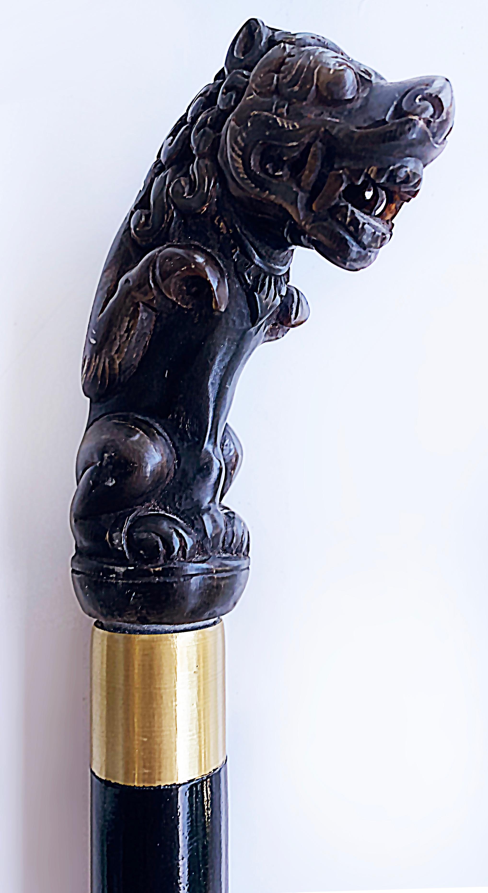 Early 1900s Carved Horn Asian Foo Dog Walking Stick with Metal Bands

Offered for sale is an early Asian 20th-century walking stick with a fine-quality carved horn foo dog top. The carving is well done with the quality that would be found in Asian