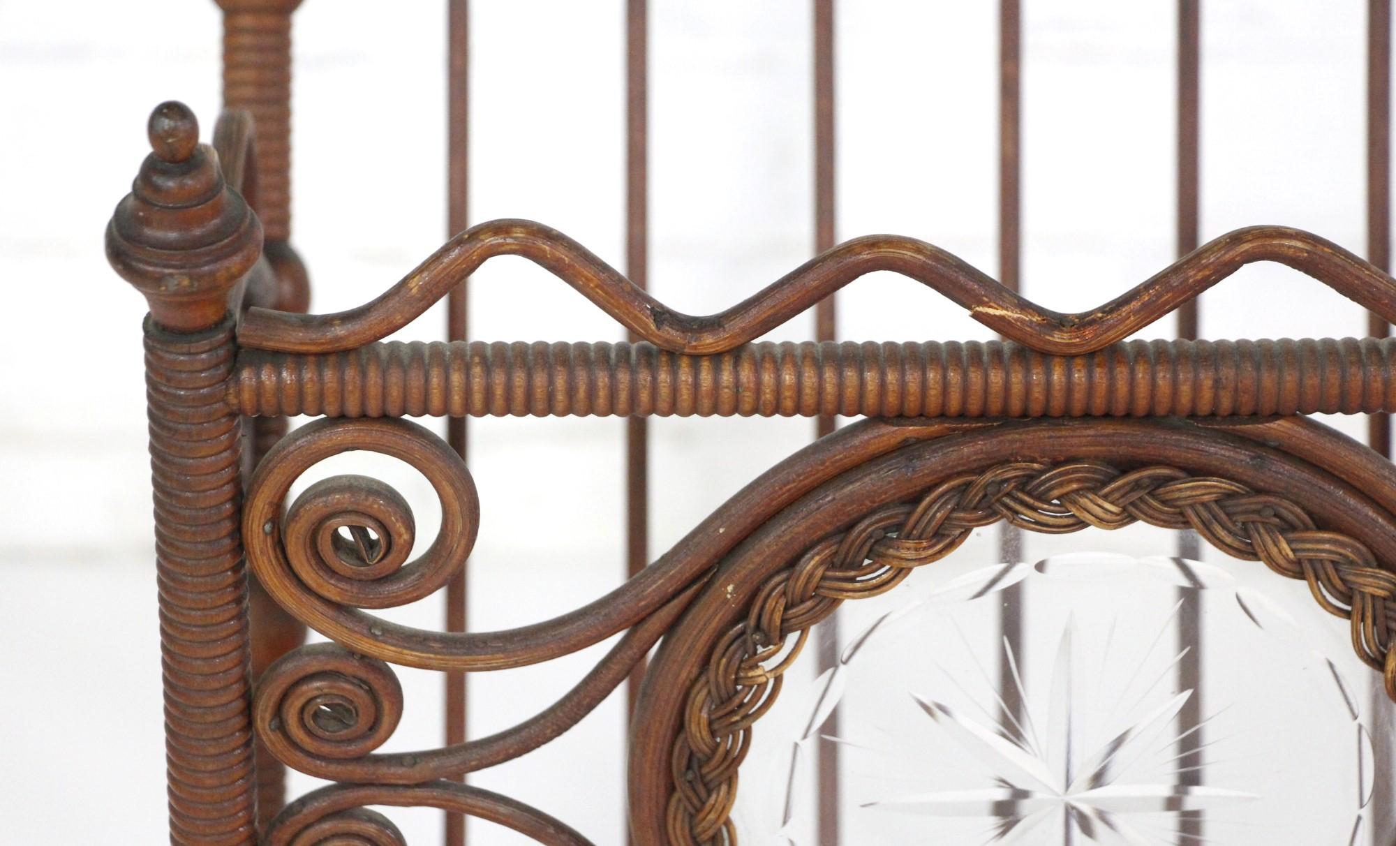 This rare antique Bentwood wicker magazine rack is very elaborate with a round etched glass motif in the center surrounded by a copper wheel. It dates to the early 1900's and is unusually ornate. This is missing two finials across the top. Please