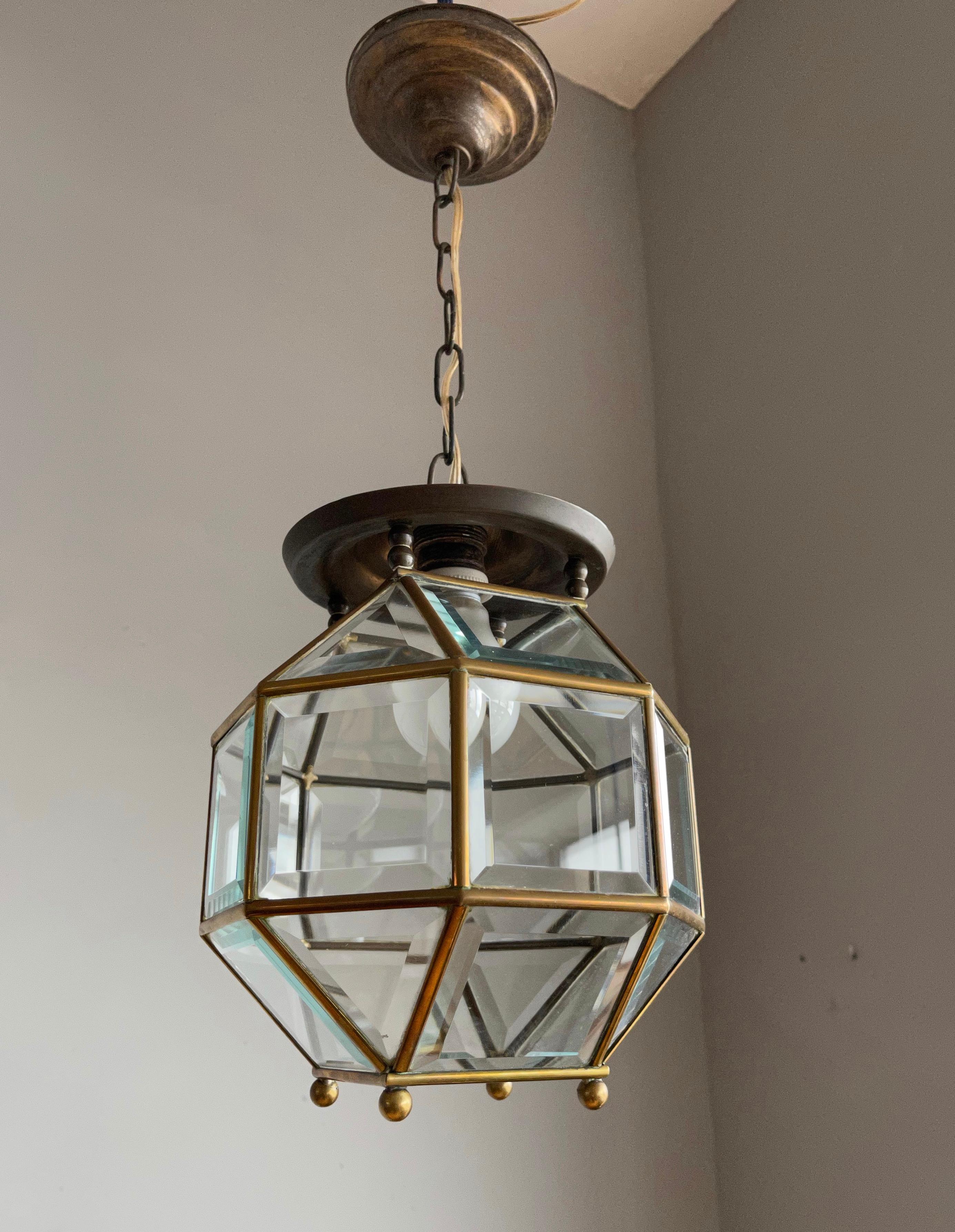 Excellent condition brass and beveled glass lantern.

This stylish design is all handmade and in excellent condition. It has a total of twenty four rectangular, beveled glass sections framed in brass and together they form a classy and timeless
