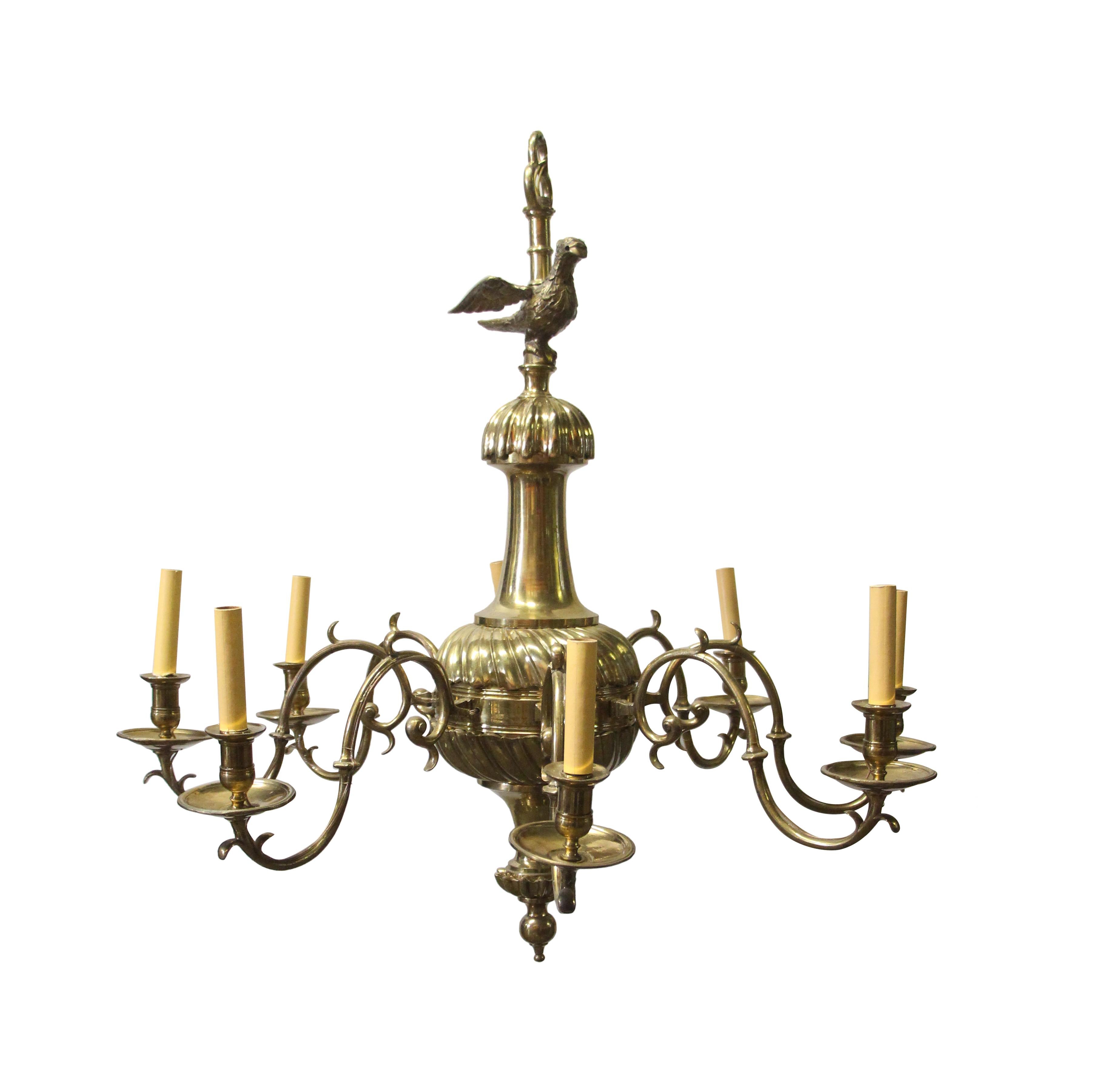 Williamsburg Style cast brass chandelier with 8-arms and eagle finial. This Early 20th Century Chandelier originally hung in the executive office of The New York Stock Exchange, New York City until the early 21st Century. The eagle has a hole where