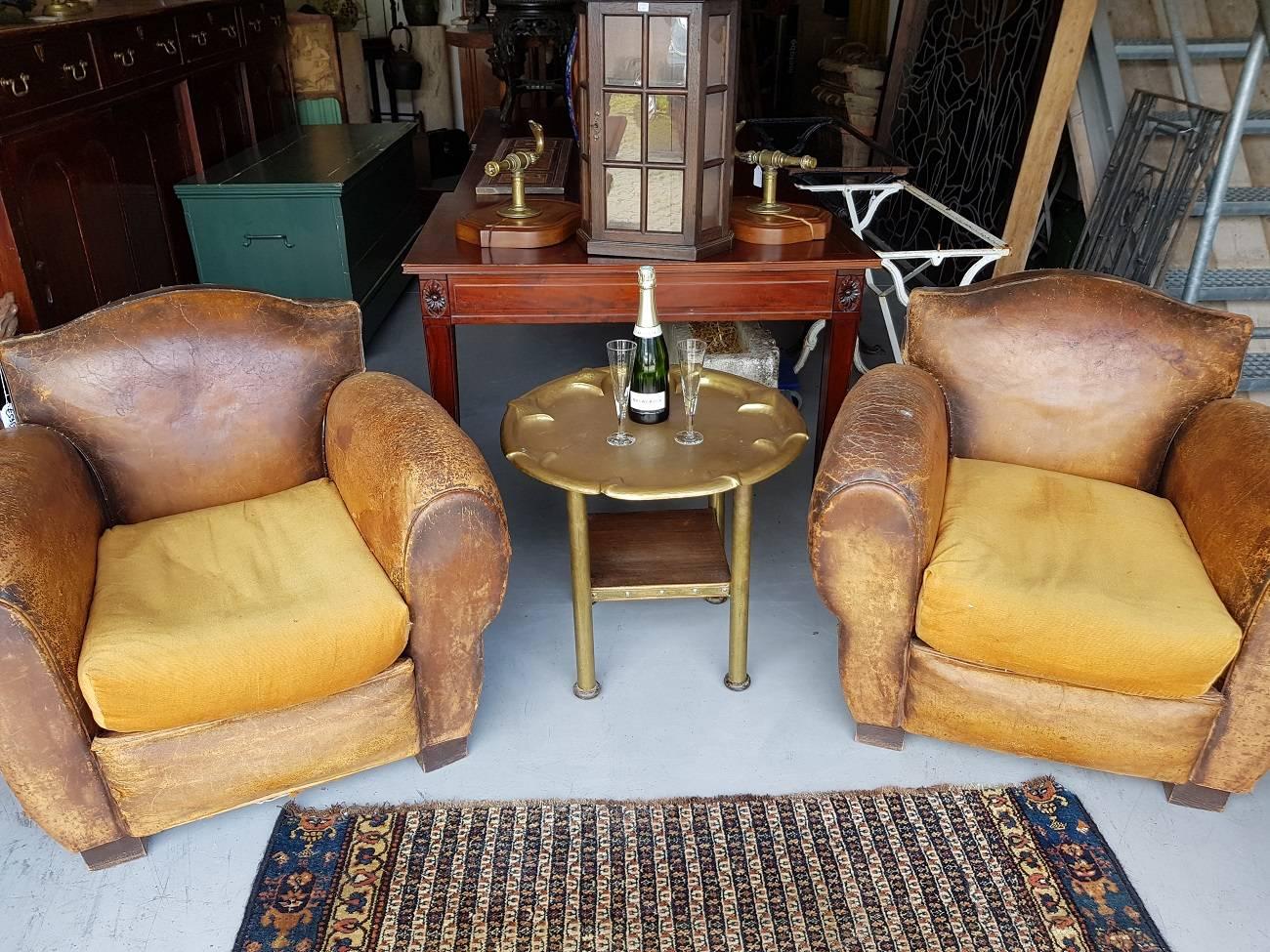 Beautiful designed smoker or cocktail side table with a hand-hammered relief and it has extra wooden shelf and standing on black painted wooden feet, early 20th century.

The measurements are,
Depth 63 cm/ 24.8 inch.
Width 63 cm/ 24.8 inch.
Height