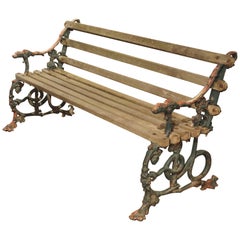 Banc en bois et fonte du début des années 1900 avec tête de chien et supports serpentins