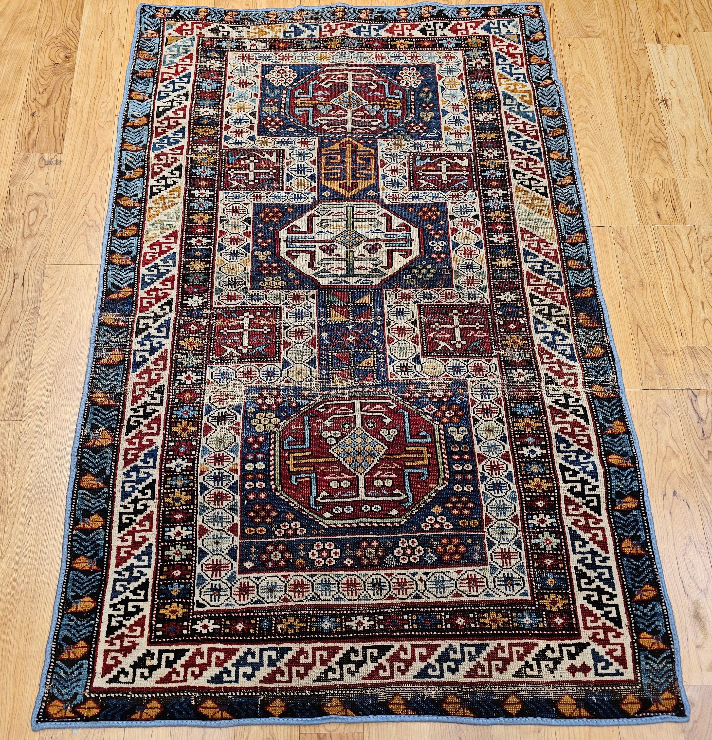 An exceptional early 1900s Caucasian Shirvan area rug from the Baku region of southeastern Azerbaijan, showcasing the artistry and vibrant aesthetics of traditional village weaving. This striking rug features a classic triple medallion pattern in