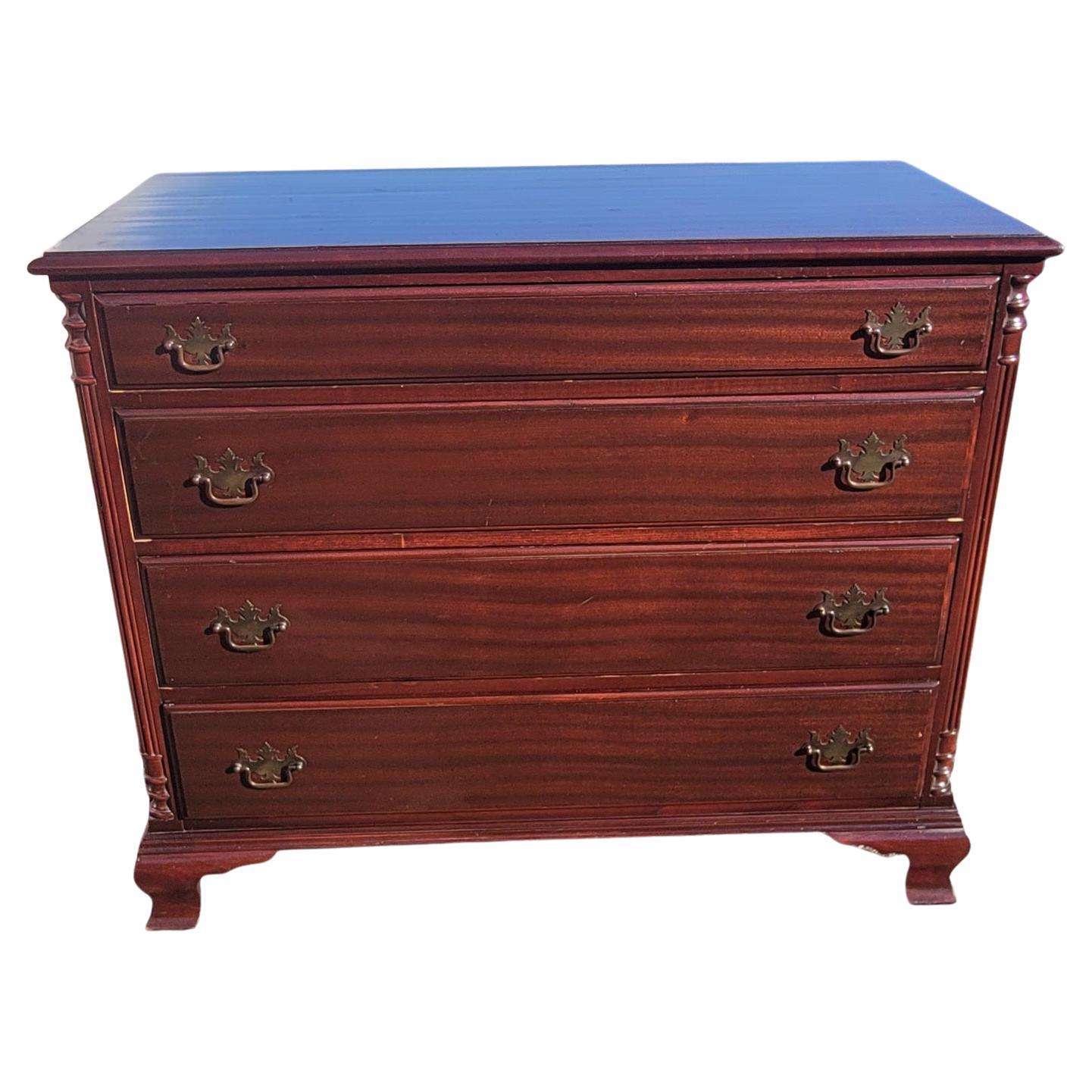 A beautiful and patinated Early 1900's Chippendale genuine Mahogany commode chest of drawers in good condition. Beautiful mahogany grain. Dovetail drawers construction with patinated original drawer pulls. Perfectly functioning drawers. Measure