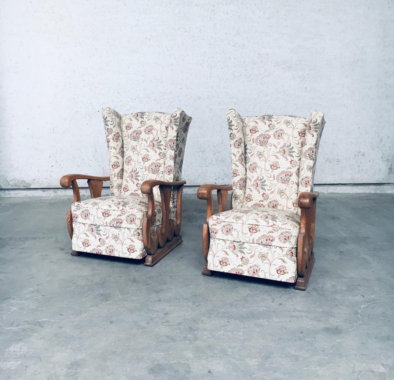 Original early 1900's design high wing back armchair Fauteuil set of 2. Made in France, 1920's - 1930's. High wing back arm chair with oak sculptural carved arm rests and recently reupholstered flower print fabric. These come from the first owner