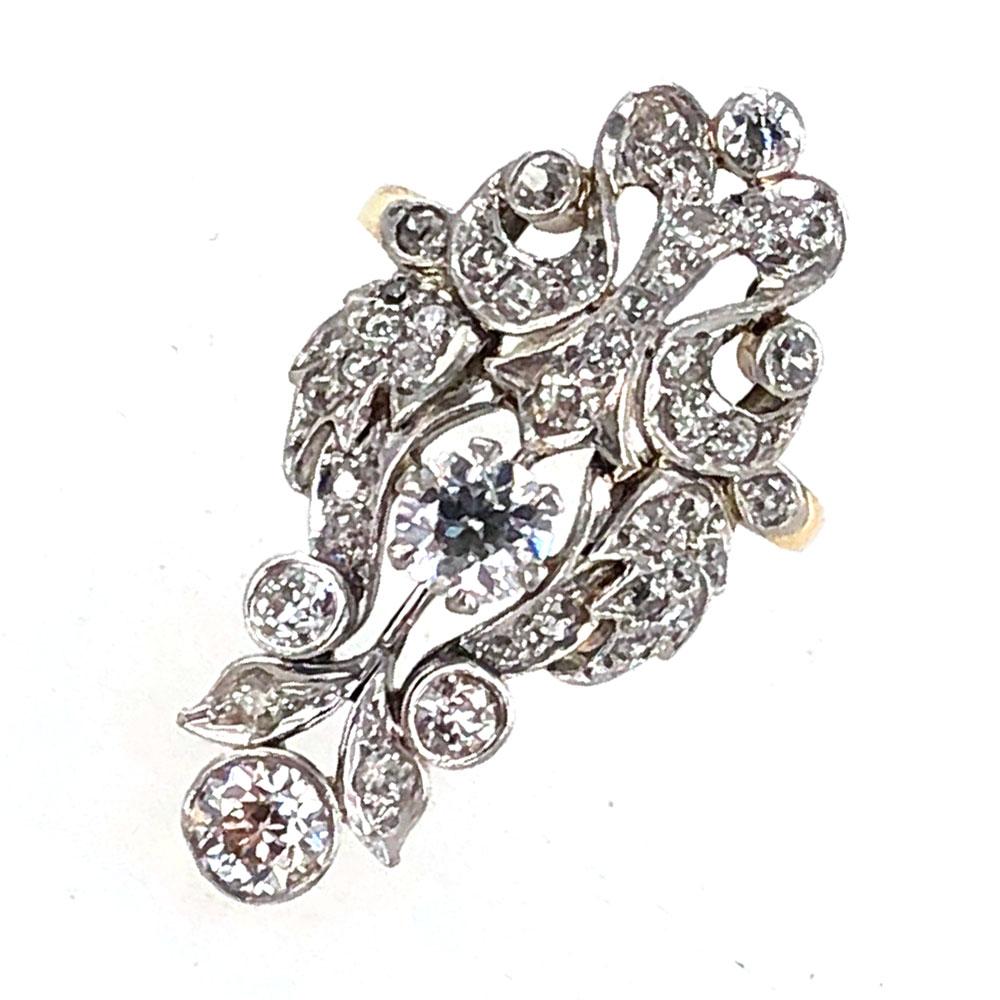 Cocktail ring circa early 1900's features 63 Old Mine Cut Diamonds. The elongated ring is crafted in two tone 14 karat gold with the white gold on top and yellow gold underneath. The largest diamond at the tip measures .50 carats, while the ring is