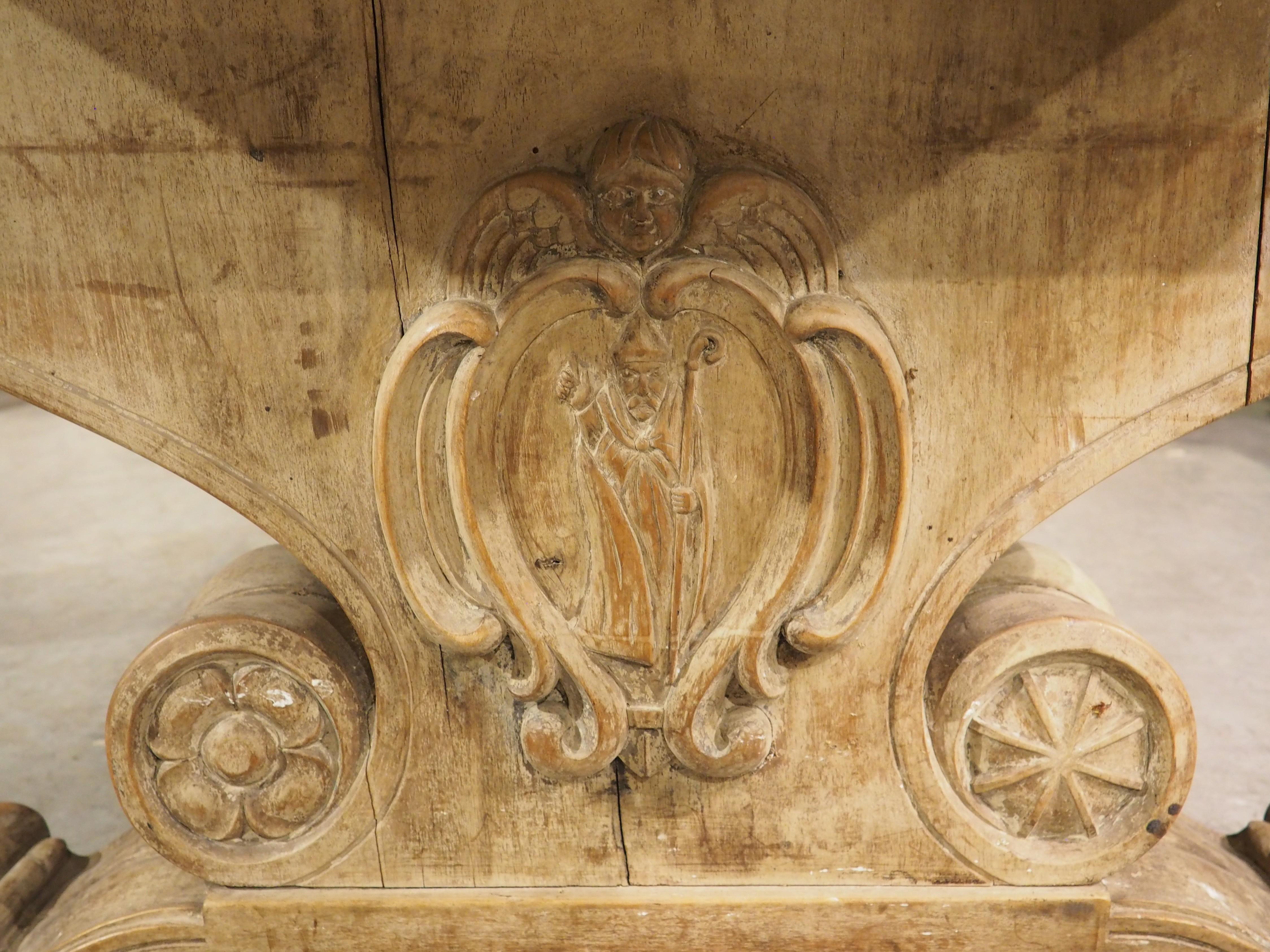 More information coming soon…

Hand-carved in France during the early 1900s, this long dining table has a uniquely shaped stretcher connecting the two trestle supports.  Both legs and the pierced stretcher have master-level carvings, adorned with