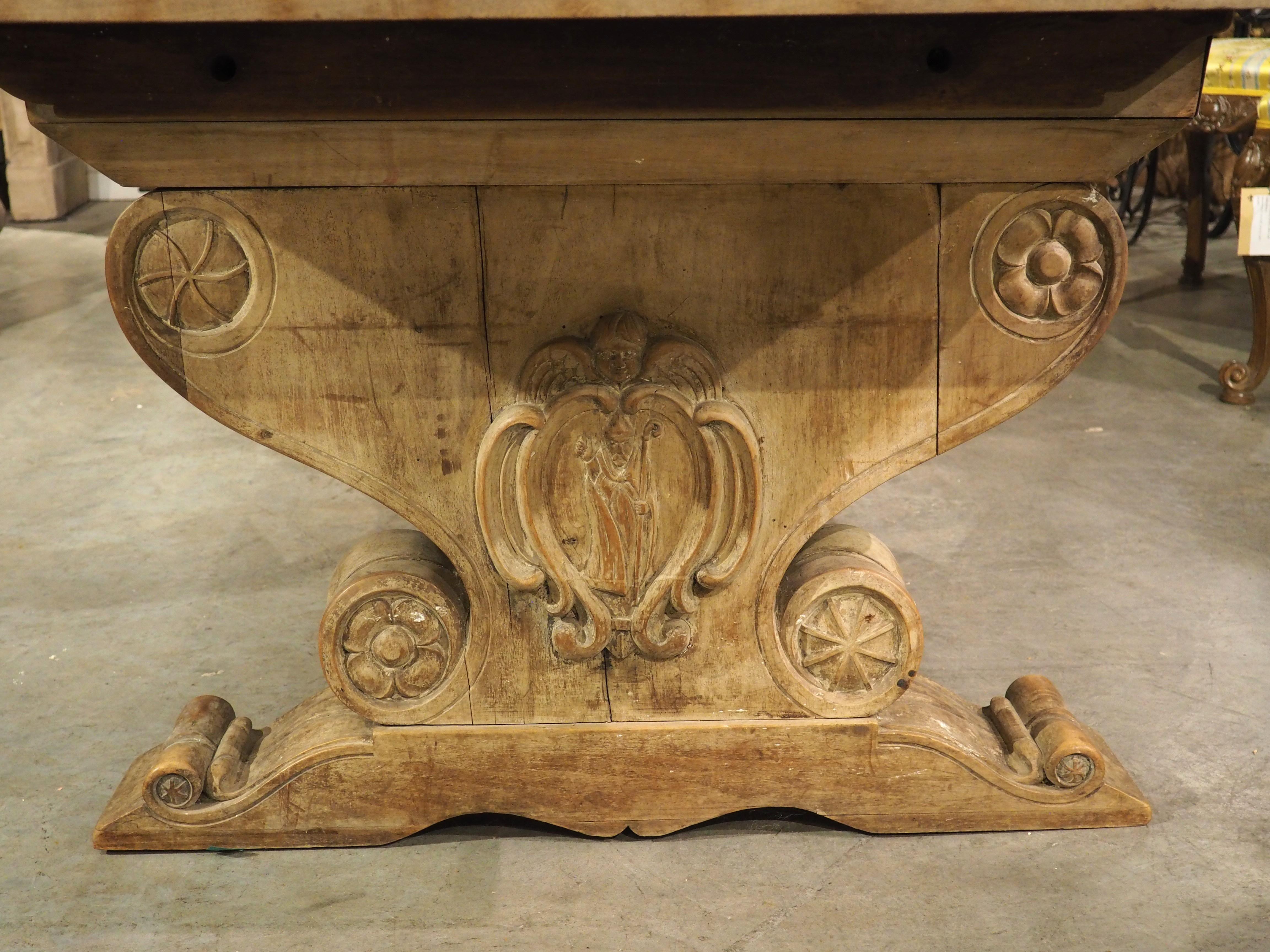 Hand-Carved Early 1900’s French Dining Table with Shaped Trestle Supports and Cartouche Carv For Sale