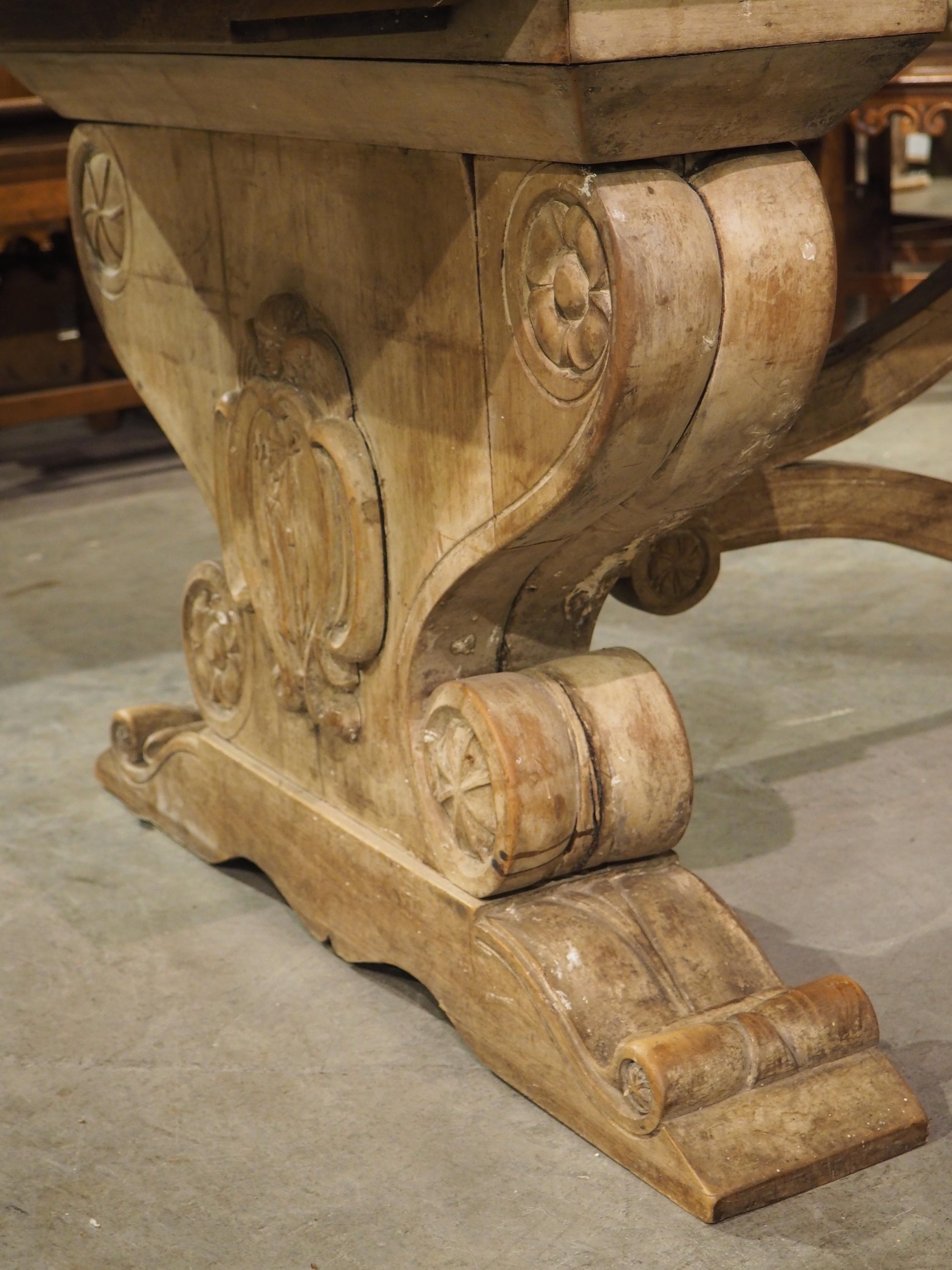Wood Early 1900’s French Dining Table with Shaped Trestle Supports and Cartouche Carv For Sale