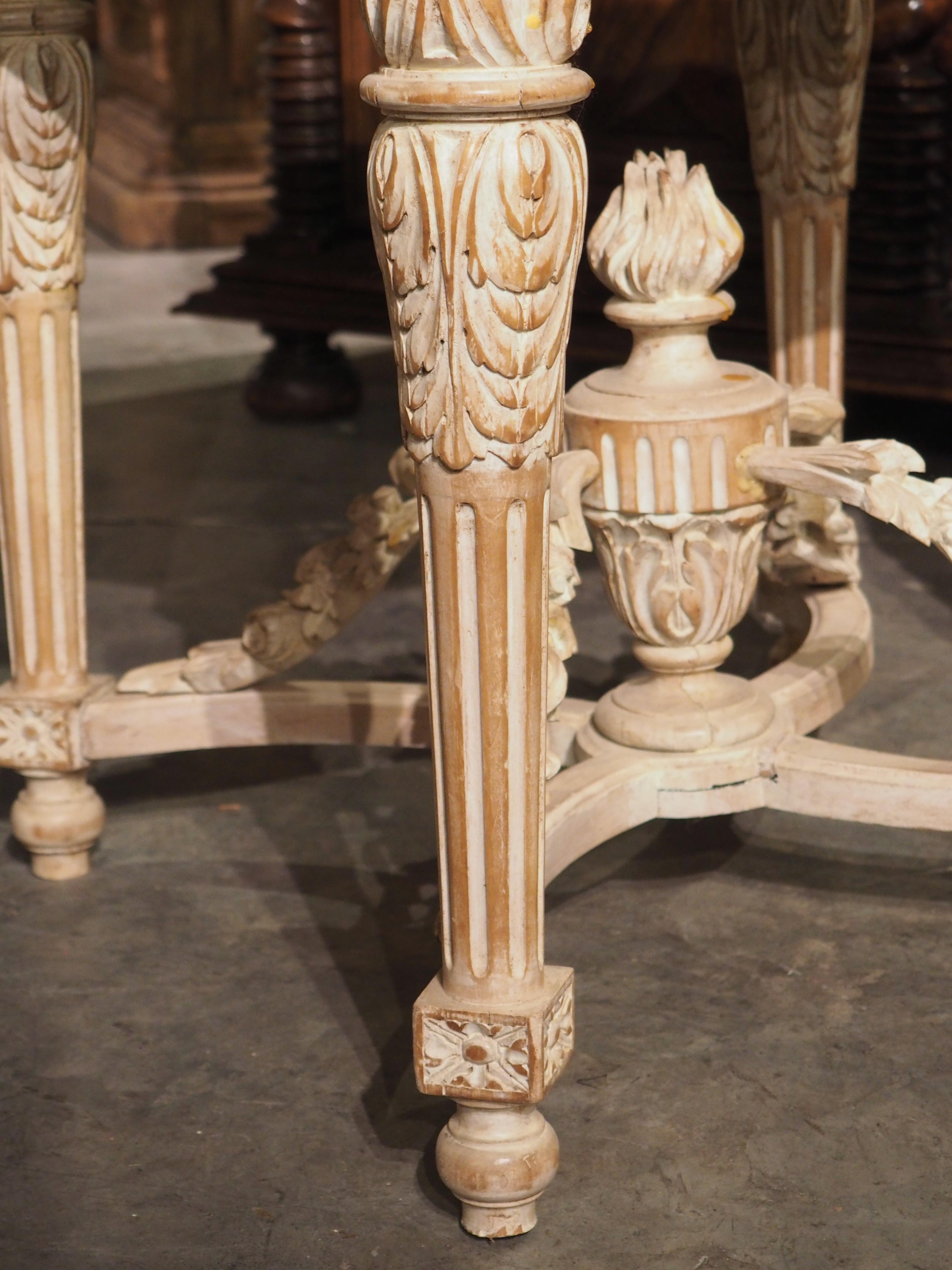 Under the direction of King Louis XVI and his court, French tables of the late 18th century followed certain guidelines, several of which can be seen on this parcel painted side table. Hand-carved in France during the early 1900’s, the small table