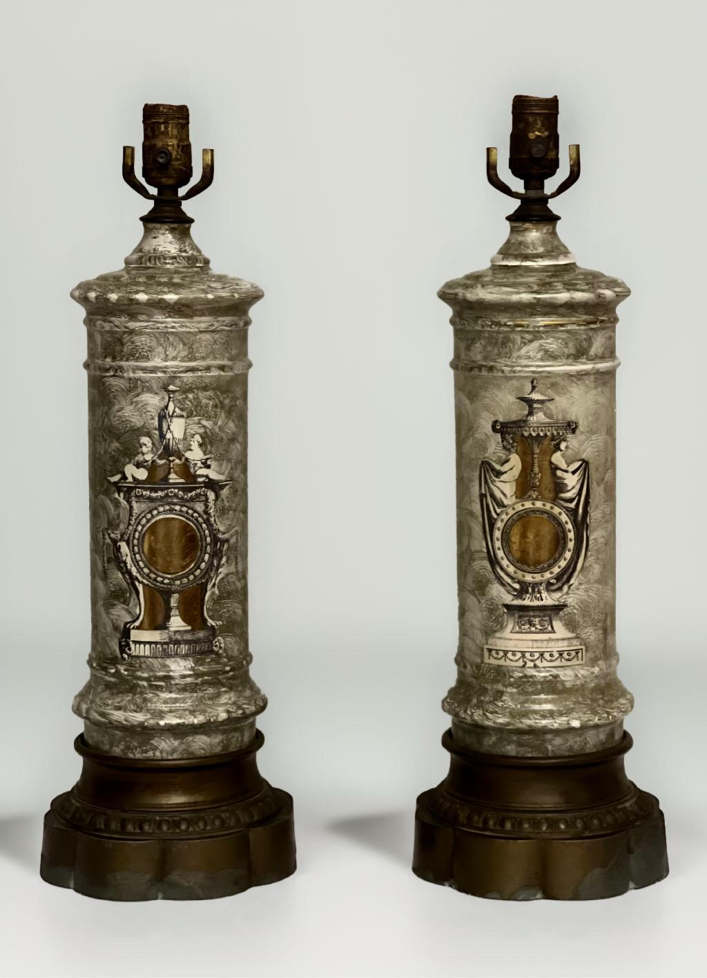 Pair of French Neoclassical style églomisé columnar lamps, c. 1910-1920.

Gorgeous pair of table lamps in églomisé with two coordinating designs. One features cherub-like figures, the other maidens in classic draped attire, both resting upon
