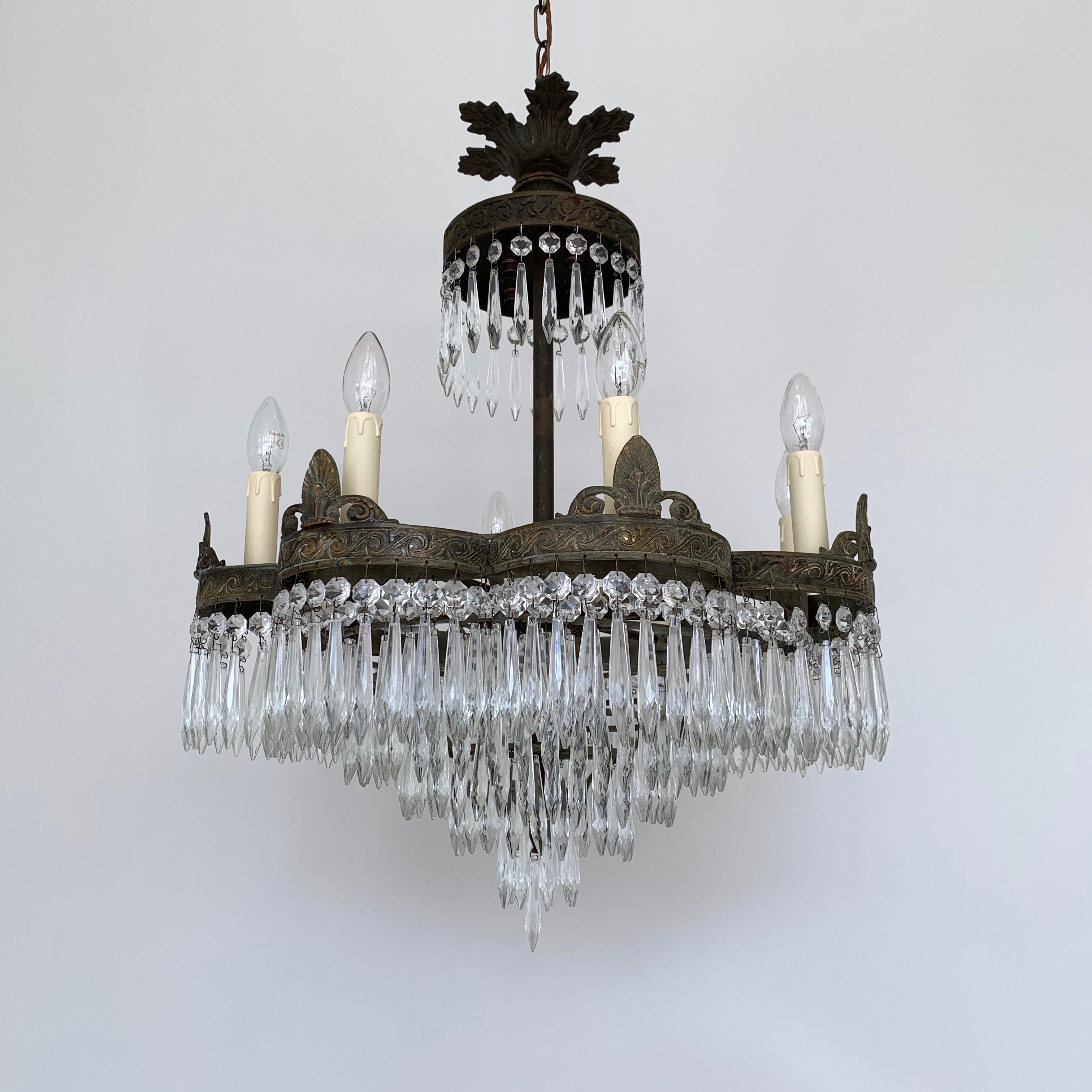 French Waterfall petal frame chandelier with glass icicle drops. 1920s French waterfall chandelier with an outer petal shaped tier. The brass frame has been sympathetically restored retaining the original antiqued brass patina. The chandelier is