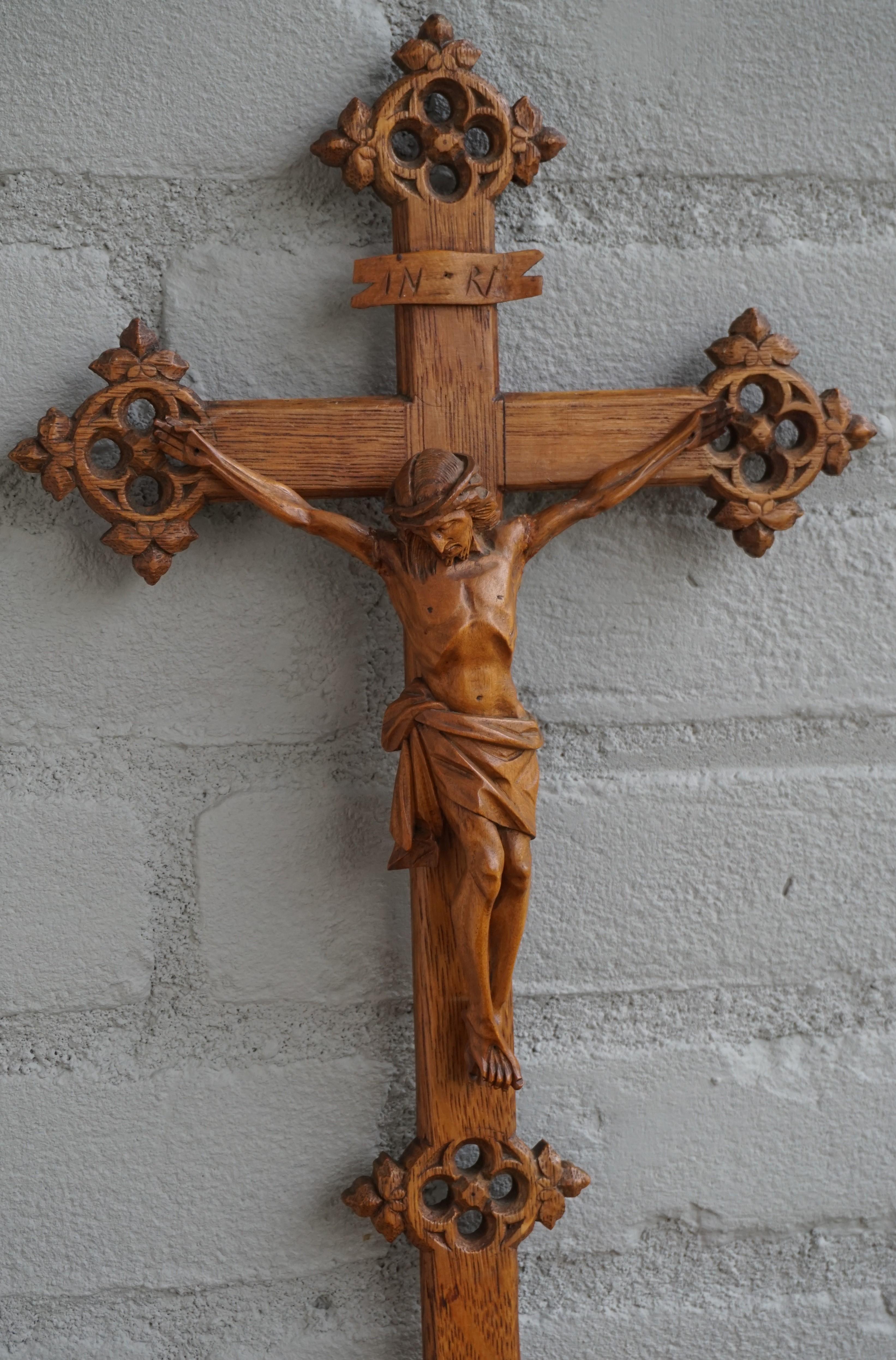 Gothic style church crucifix with an incredibly detailed corpus of Christ.

What makes this stylish crucifix extra rare are the Gothic elements that are hand carved on the ends of each side of the cross and also in the base. This medieval style